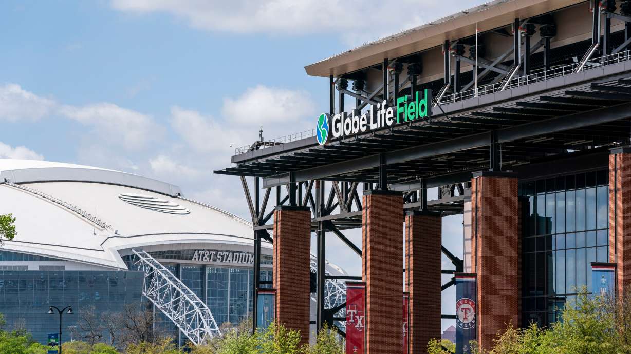 FILE - The facade of Globe Life Field stands in front of the Dallas Cowboys' AT&T Stadium before a baseball game between the Texas Rangers and the Toronto Blue Jays, April 5, 2021, in Arlington, Texas.