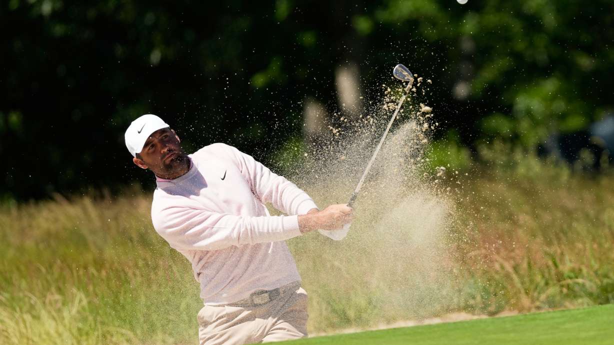 Scottie Scheffler hits from the bunker on the second hole during a practice round for the U.S. Open golf tournament at Shinnecock Hills Golf Club in Southampton, N.Y., Tuesday, June 16, 2026.