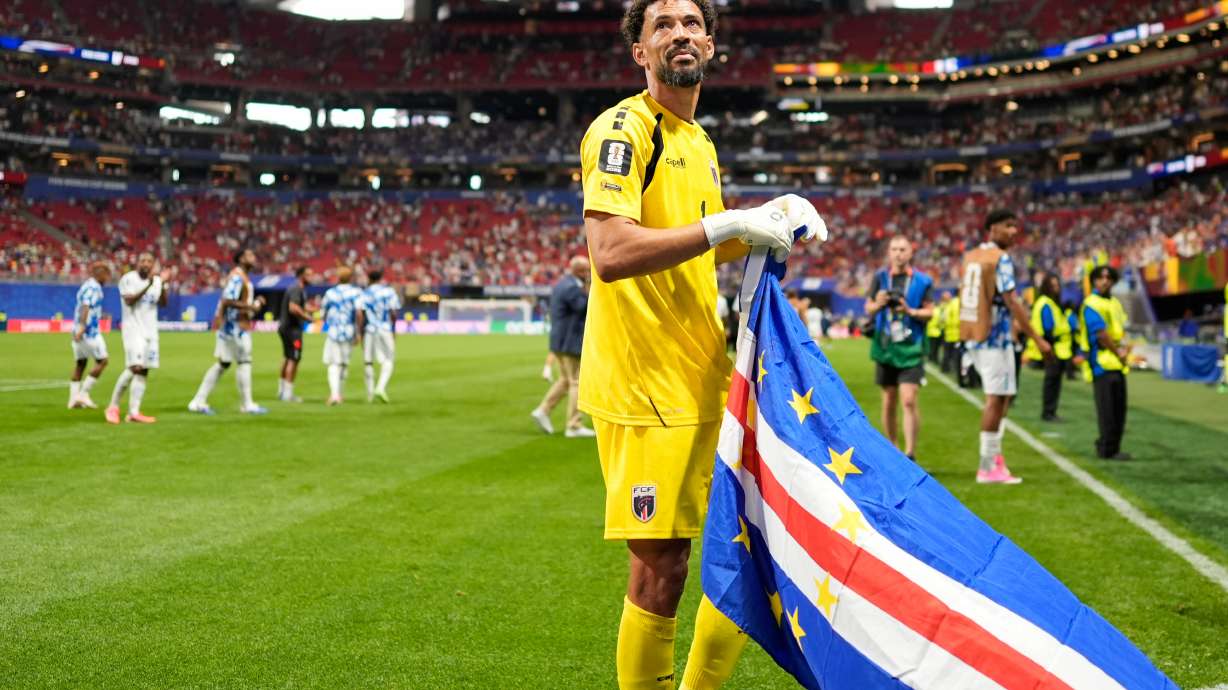 Cape Verde goalkeeper Vozinha celebrates as holds the flag of his country after the World Cup Group H soccer match between Spain and Cape Verde in Atlanta, Monday, June 15, 2026.