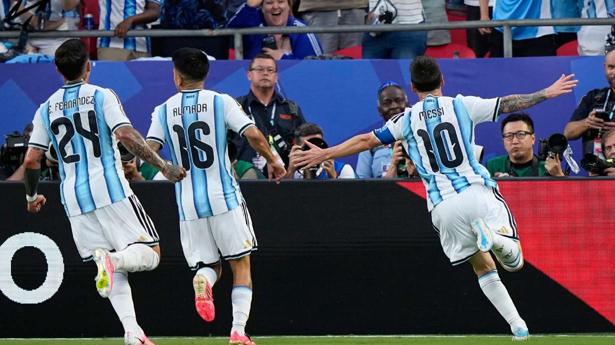 Argentina's Lionel Messi, right, celebrates after scoring his team's first goal during the World Cup Group J soccer match between Argentina and Algeria in Kansas City, Mo., Tuesday, June 16, 2026.