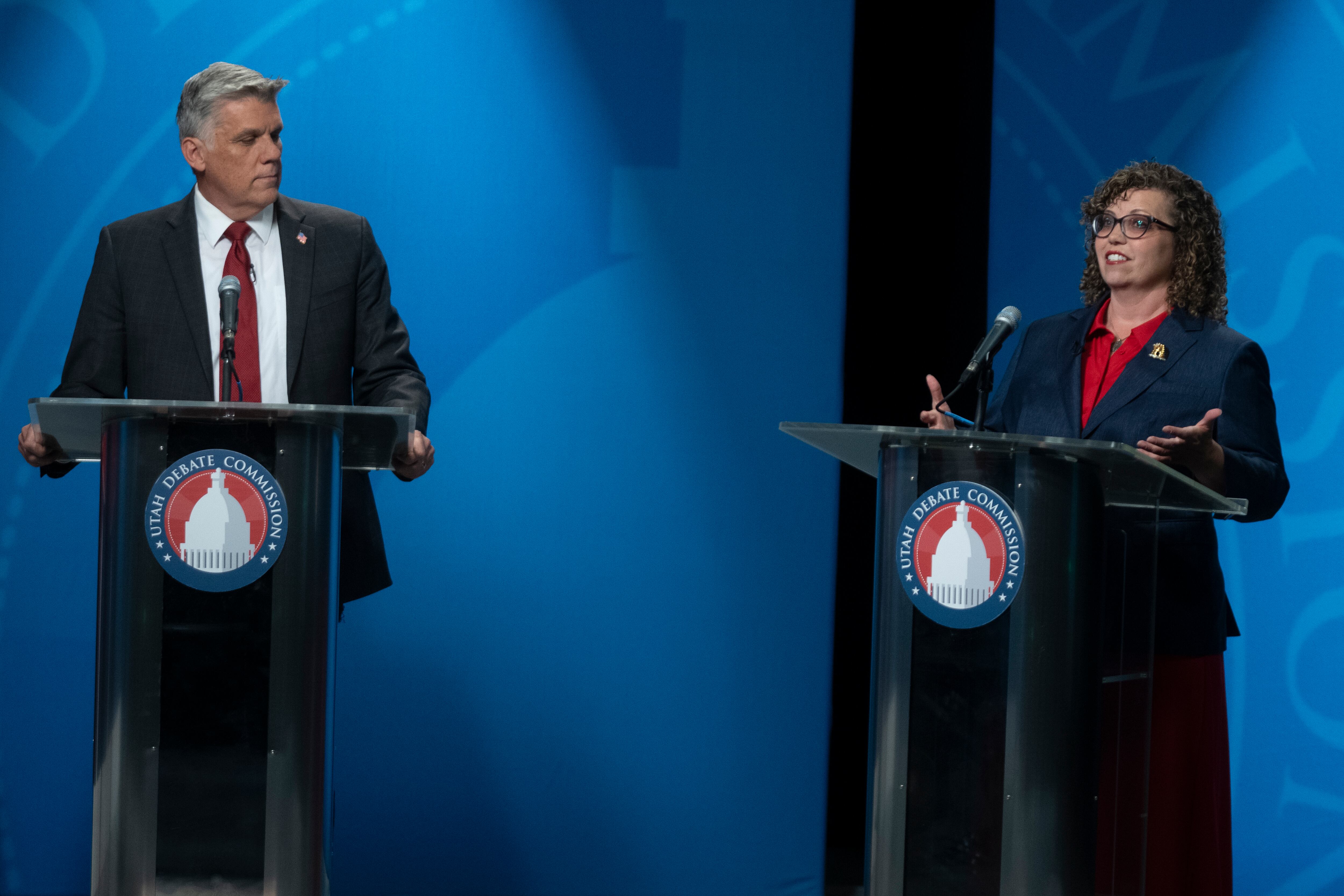 Phil Lyman watches as Celeste Maloy speaks during the 3rd Congressional District Republican primary debate in Salt Lake City on June 1. Maloy has outspent Lyman nearly 10 to 1 in the last two months.