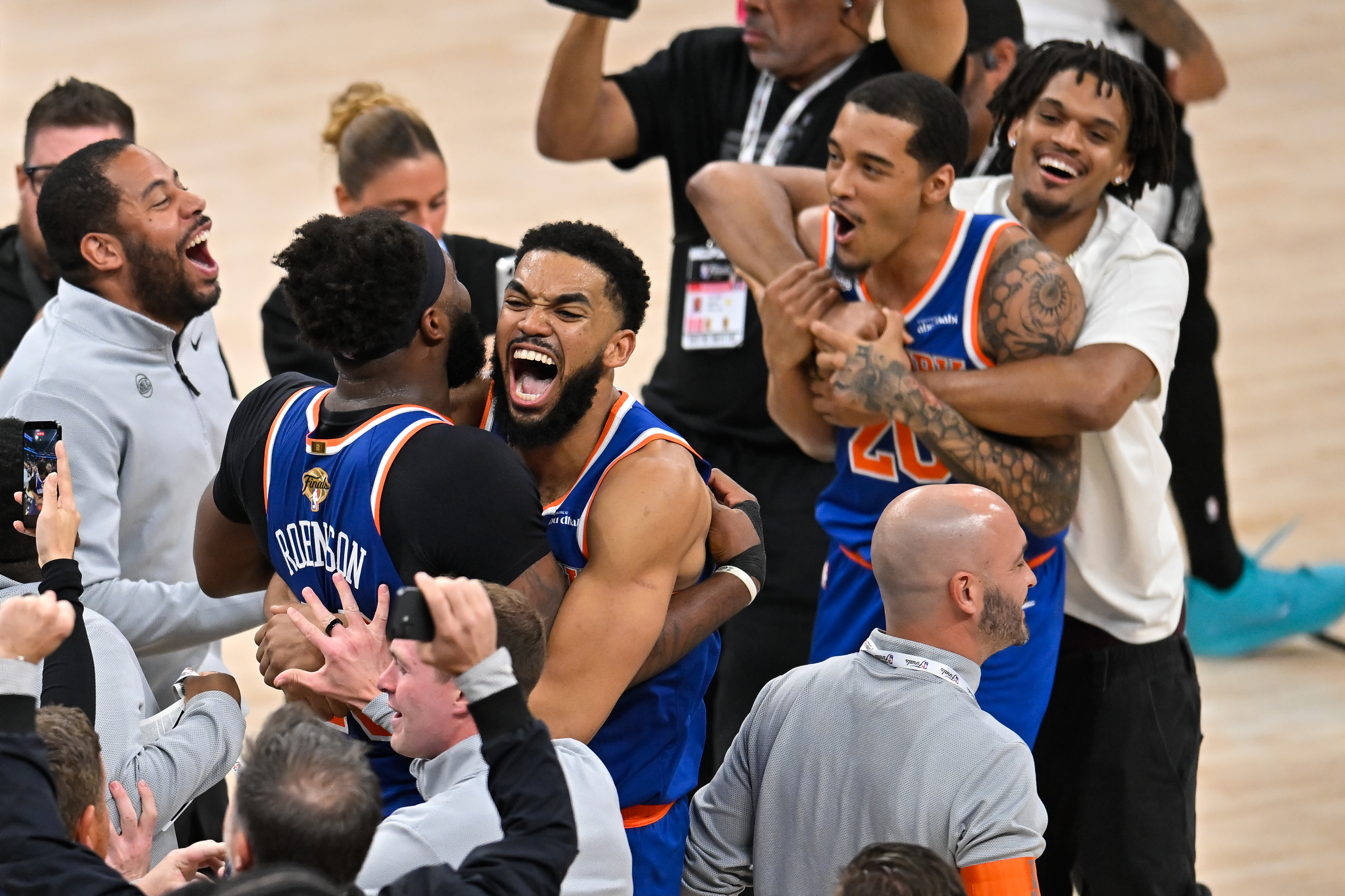 New York Knicks center Karl-Anthony Towns, right, hugs center Mitchell Robinson after defeating the San Antonio Spurs in Game 5 of the NBA Finals basketball series, Saturday, June 13, 2026, in San Antonio. CORRECTION: corrects ID to Mitchell Robinson instead Og Anunoby