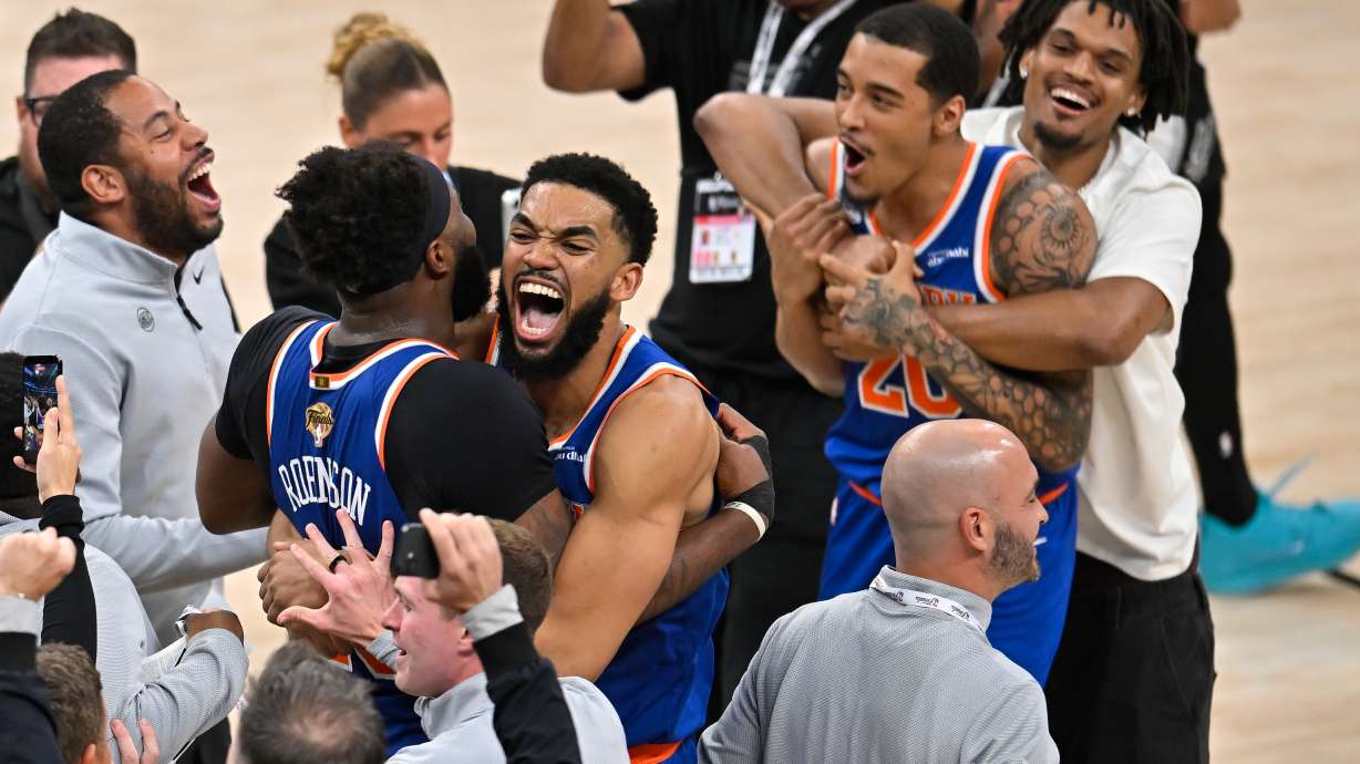 New York Knicks center Karl-Anthony Towns, right, hugs center Mitchell Robinson after defeating the San Antonio Spurs in Game 5 of the NBA Finals basketball series, Saturday, June 13, 2026, in San Antonio. CORRECTION: corrects ID to Mitchell Robinson instead Og Anunoby
