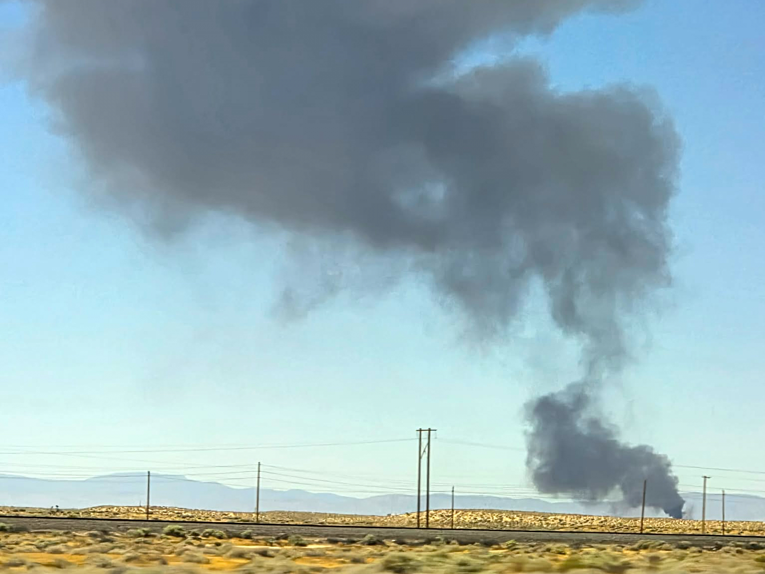 Smoke plumes rise from a B-52 bomber that crashed shortly after takeoff at a U.S. Air Force base in Southern California, Monday. Officials identified all eight victims of the crash on Wednesday.