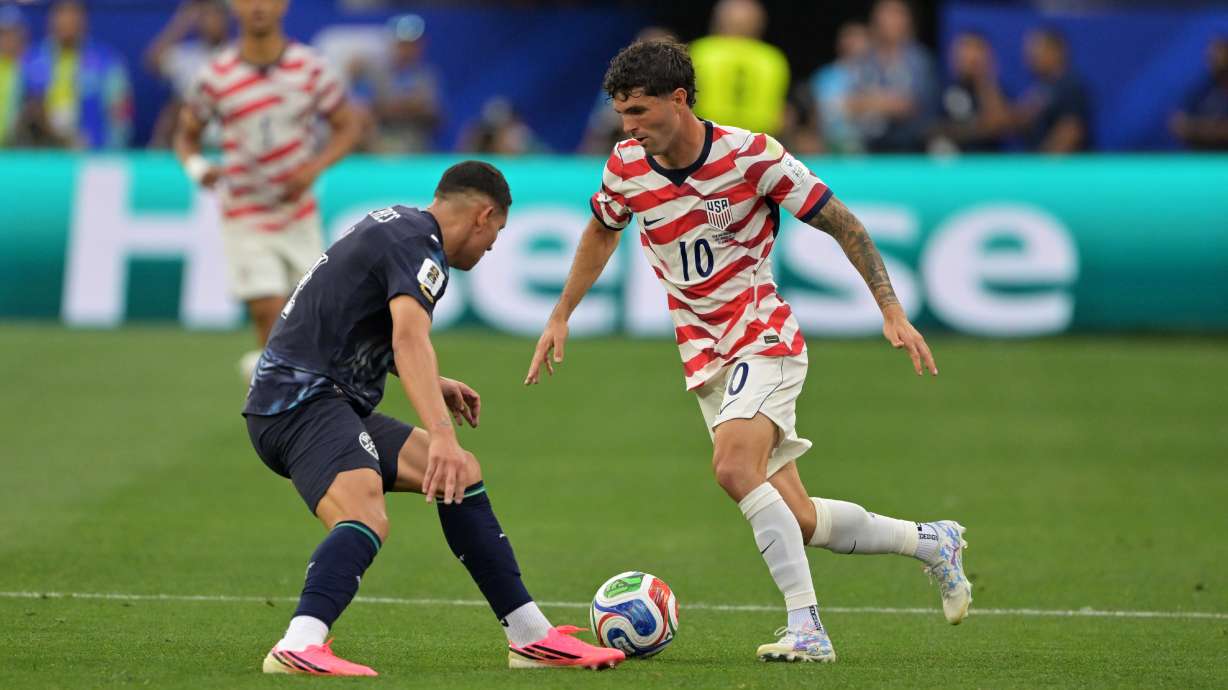 United States' Christian Pulisic (10) dribbles past Paraguay's Juan Jose Caceres during the World Cup Group D soccer match in Inglewood, Calif., near Los Angeles, Friday, June 12, 2026.