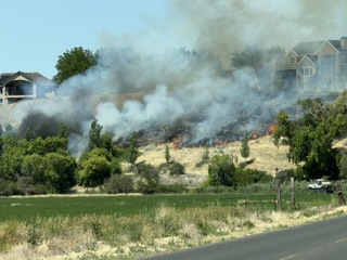 Crews knock down brush fire started by city lawnmower near homes in Spanish Fork
