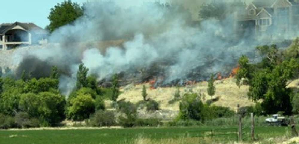 Crews knock down brush fire started by city lawnmower near homes in Spanish Fork