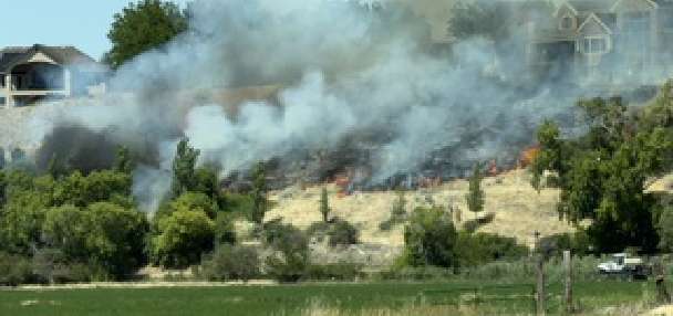 Crews knock down brush fire started by city lawnmower near homes in Spanish Fork