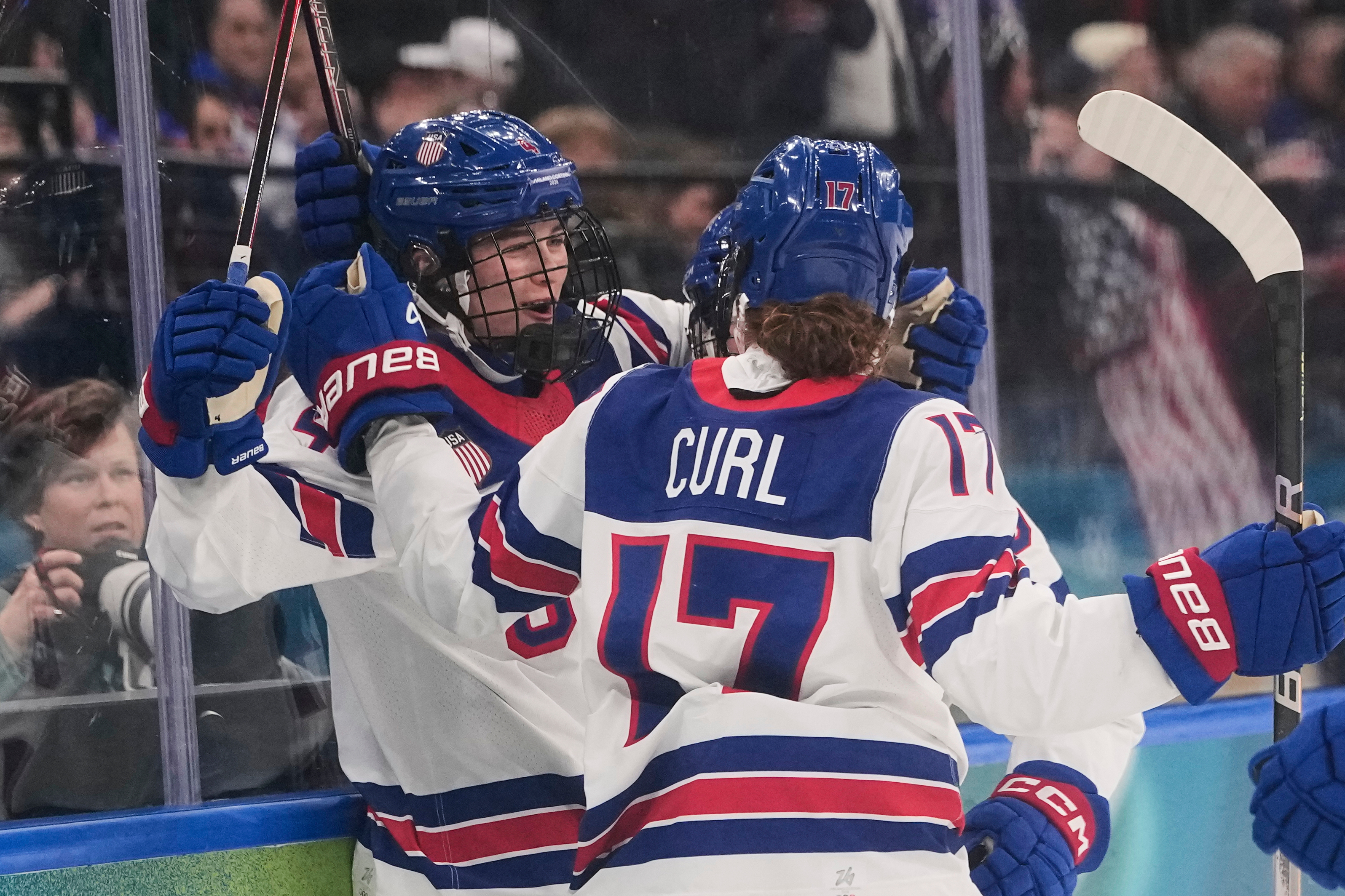 FILE - United States' Caroline Harvey celebrates with teammates after scoring her side's first goal during a preliminary round match of women's ice hockey between USA and Canada at the 2026 Winter Olympics, in Milan, Feb. 10, 2026.