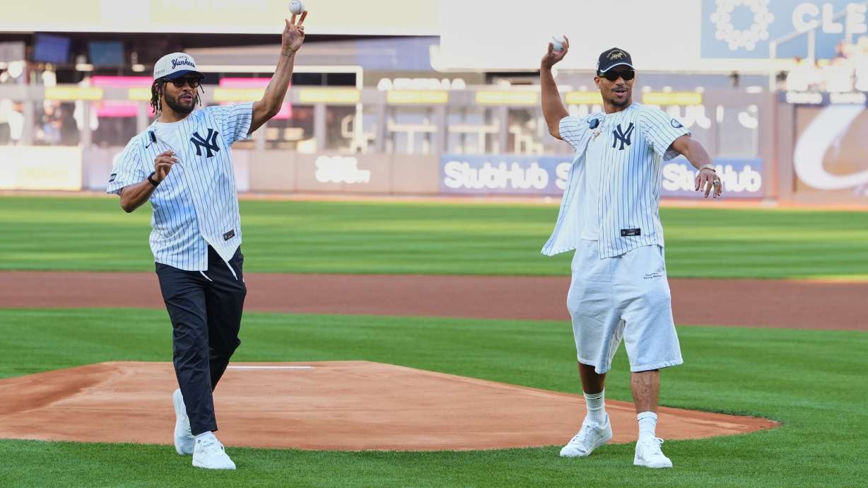 New York Knicks' Josh Hart, right, and Jalen Brunson throw out a ceremonial first pitch before a baseball game between the Chicago White Sox and the New York Yankees Wednesday, June 17, 2026, in New York.