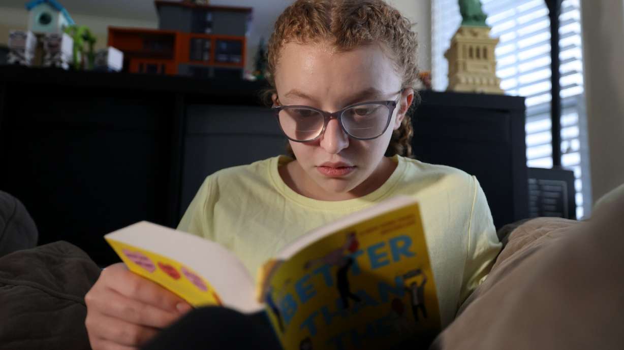 Nicole Baun, 15, reads at home in South Jordan on Wednesday. The teen's birthday wish list makes her a bit of an adolescent outlier: books, and then more books.