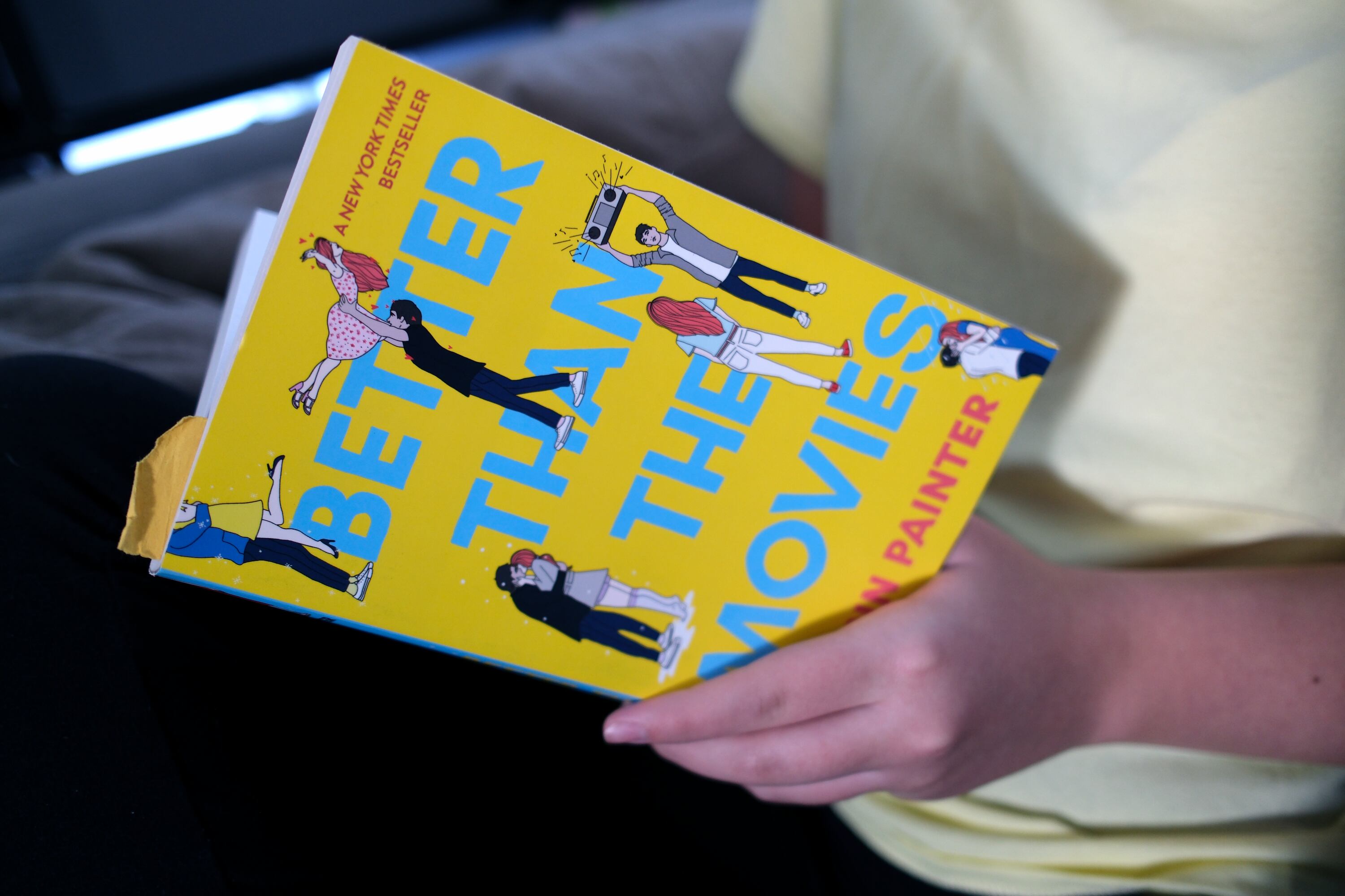 Nicole Baun, 15, shows what book she is reading at home in South Jordan on Wednesday, which is the third or fourth time she has read this book. First lady Abby Cox said adolescents need reading examples like Nicole in their homes.