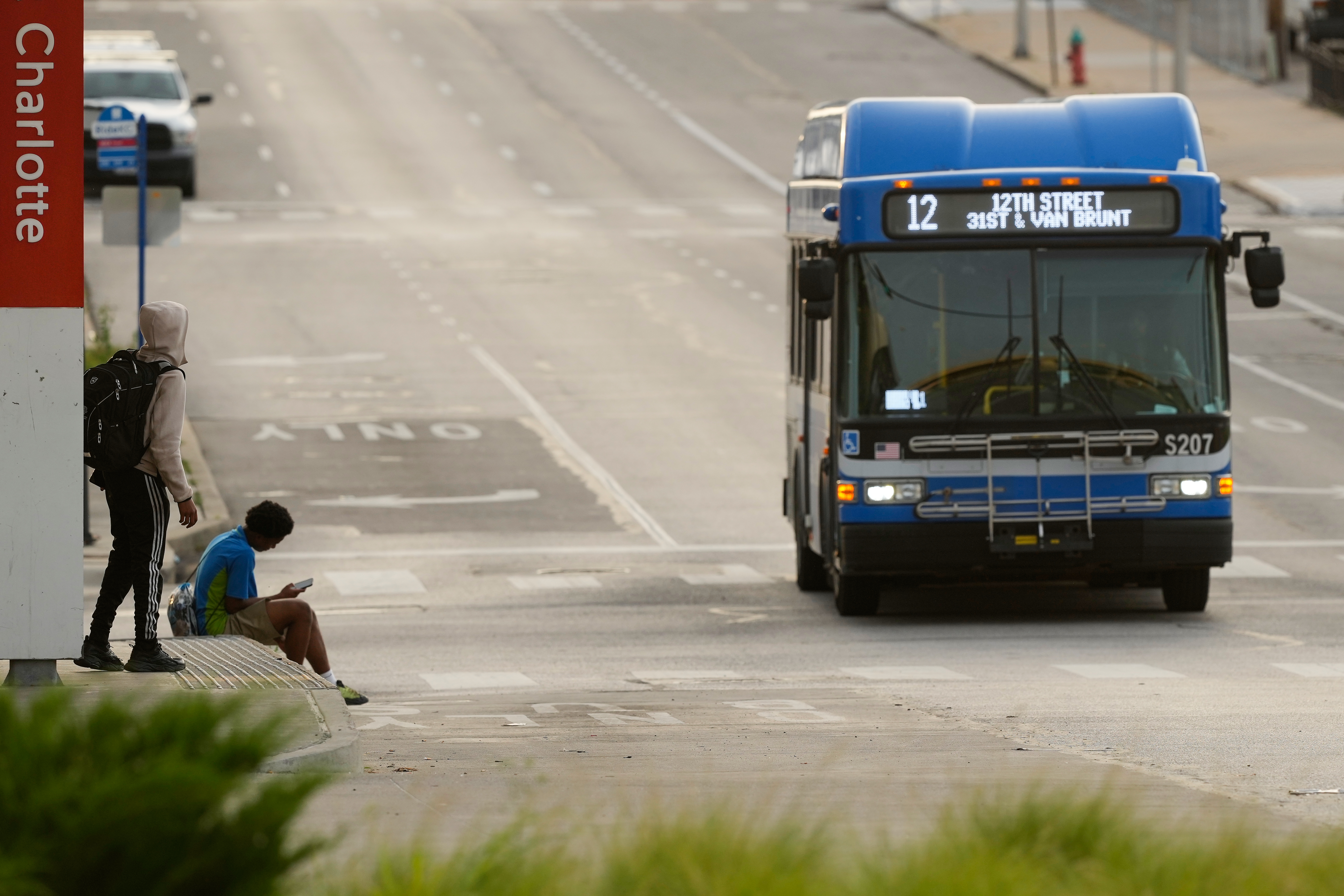 People wait for the bus at a transit center Friday, June 5, 2026, in Kansas City, Mo.