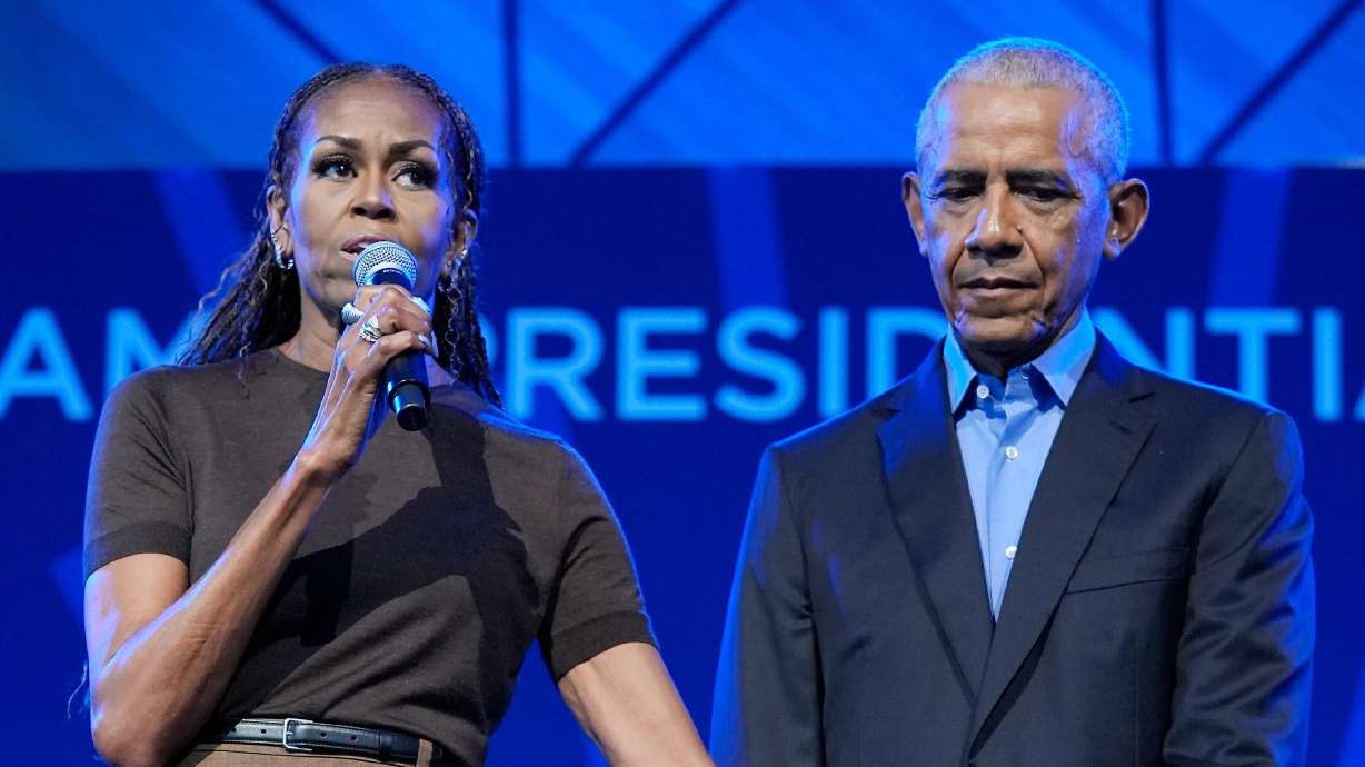 Former President Barack Obama stands on stage with former first lady Michelle Obama at a stakeholders event at the Obama Presidential Center, Tuesday, in Chicago. The Obamas dedicated their presidential library on Thursday.