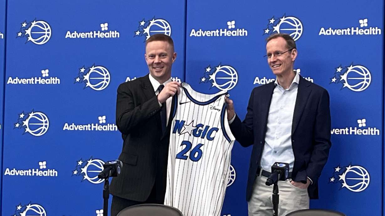 New Orlando Magic coach Sean Sweeney, left, is introduced by Magic president Jeff Weltman at a news conference at the team's training facility Thursday, June 18, 2026, in Orlando, Fla.