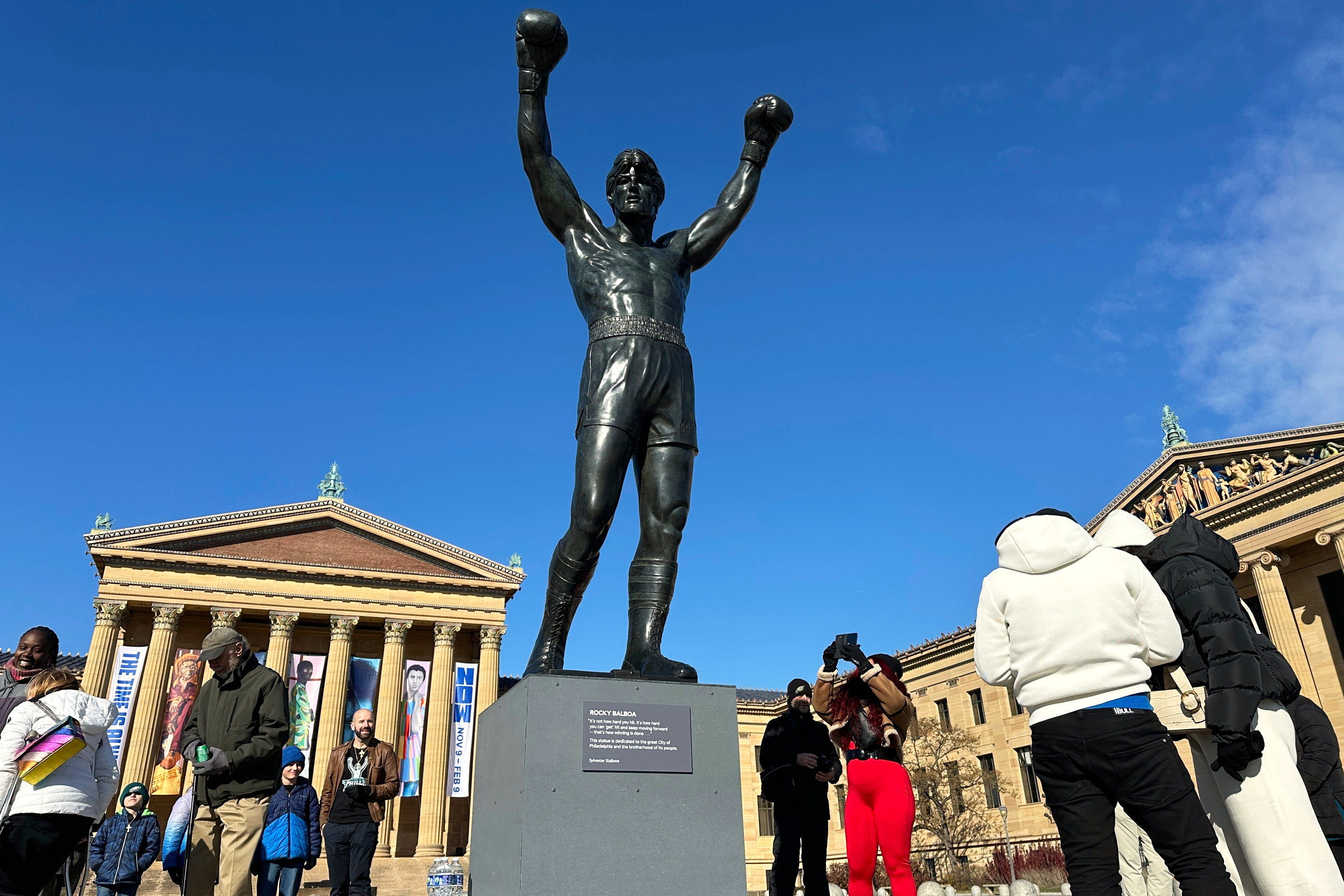 FILE - Visitors gather around the Rocky Statue during RockyFest 2024 at the Philadelphia Museum of Art, Dec. 3, 2024, in Philadelphia.