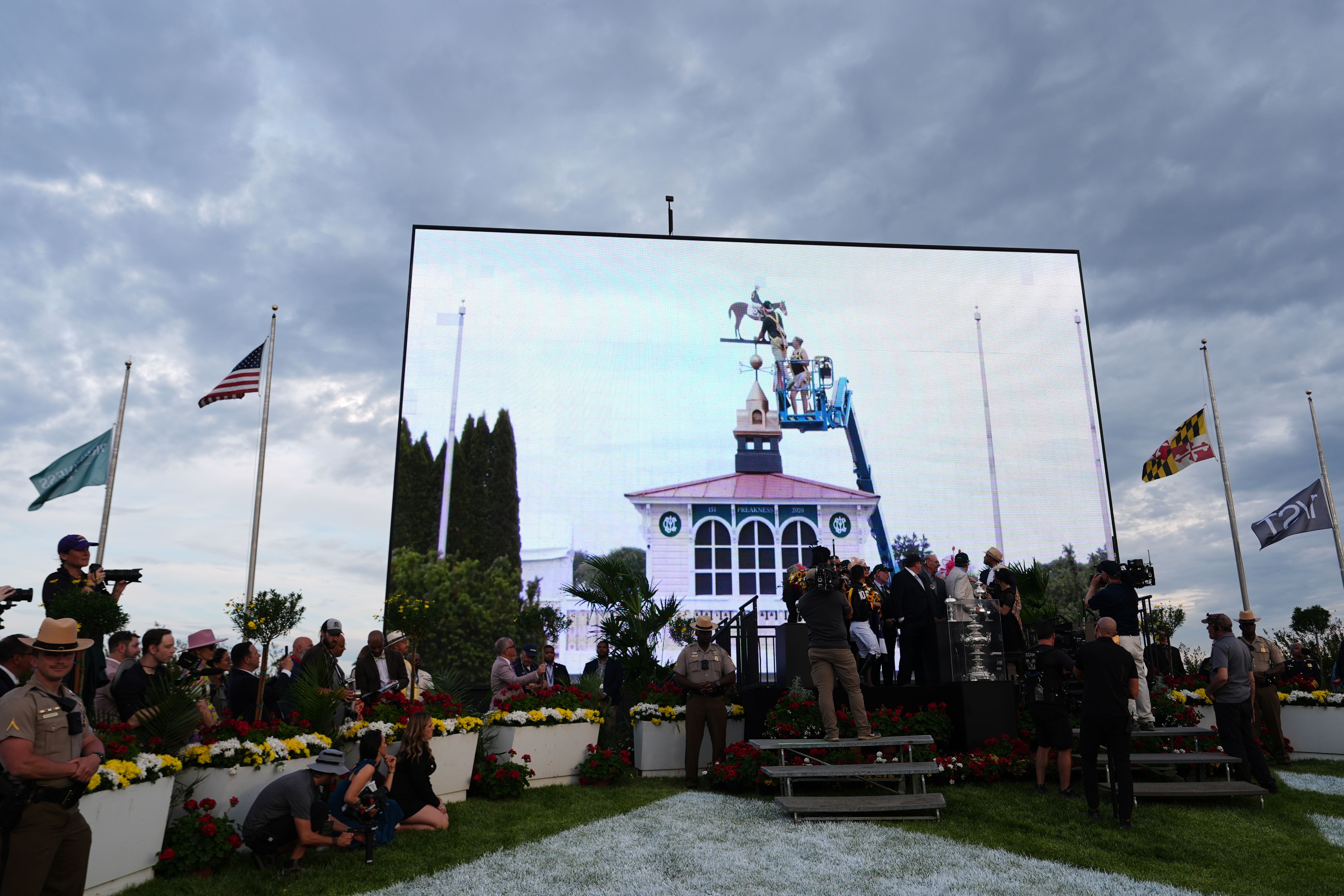 FILE - A broadcast shows staff painting the new colors of Paco Lopez and Napoleon Solo on the Pimlico weather vane after they won the 151st running of the Preakness Stakes horse race, May 16, 2026, at Laurel Park in Laurel, Md.