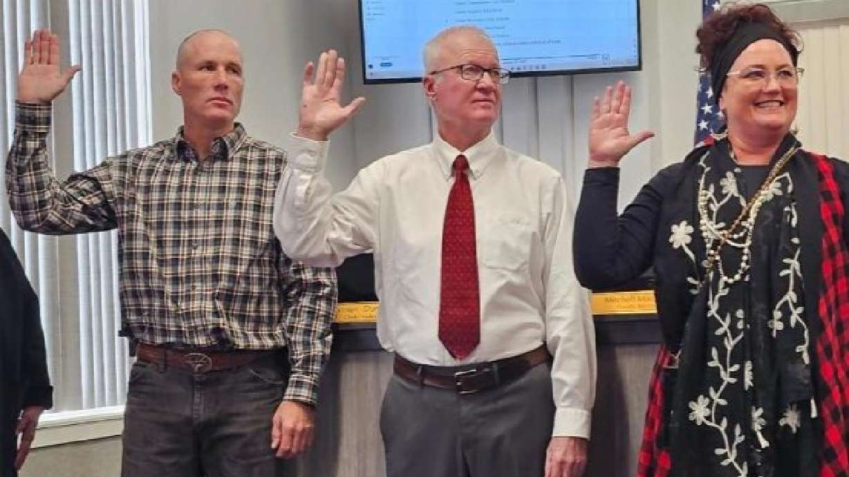 Rick Meyer, center, is pictured in a January 2025 photo being sworn in for his second term as San Juan County assessor. Meyer resigned, effective Monday.
