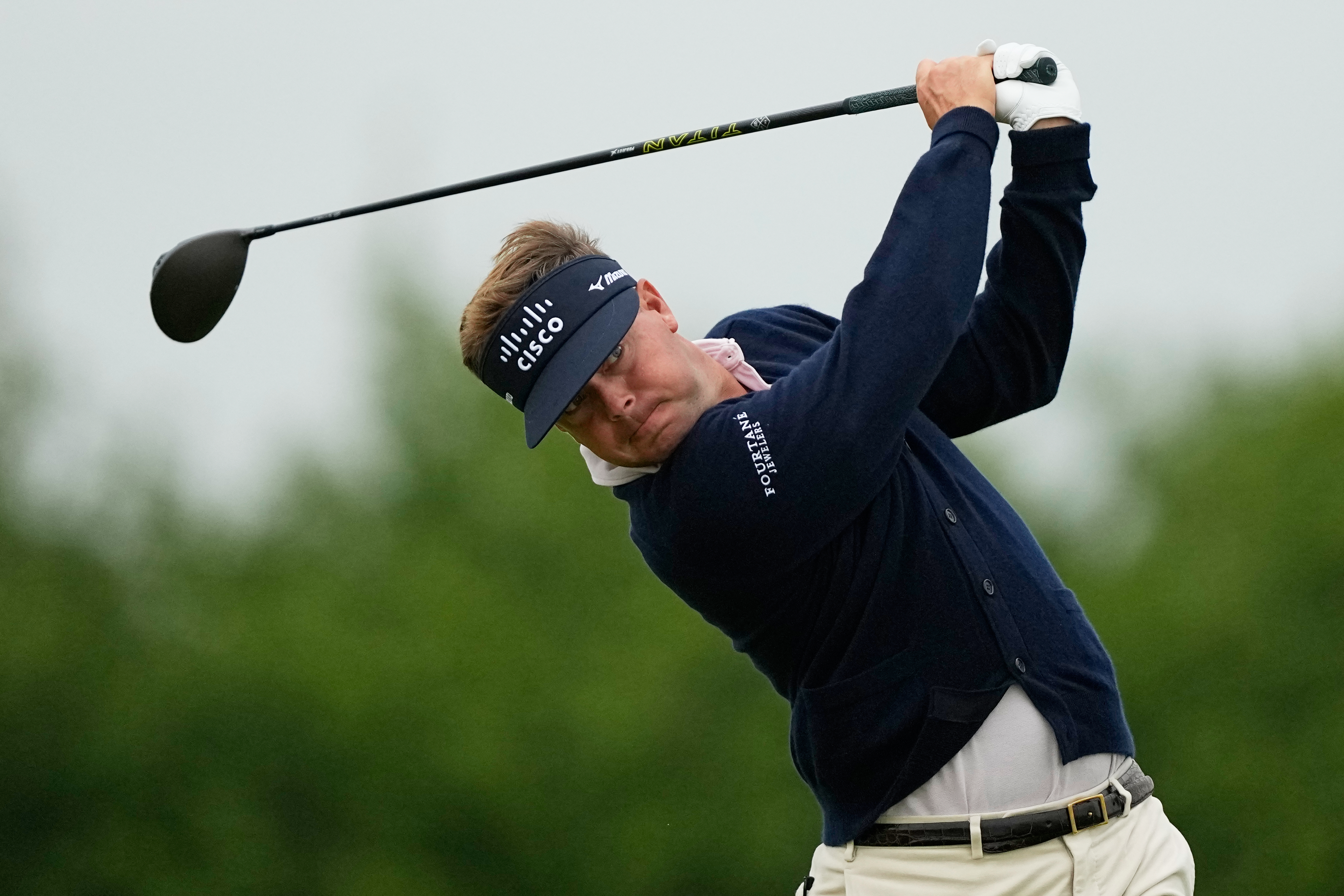 Keith Mitchell watches his tee shot on the 13th hole during the first round of the U.S. Open golf tournament at Shinnecock Hills Golf Club in Southampton, N.Y., Thursday, June 18, 2026.