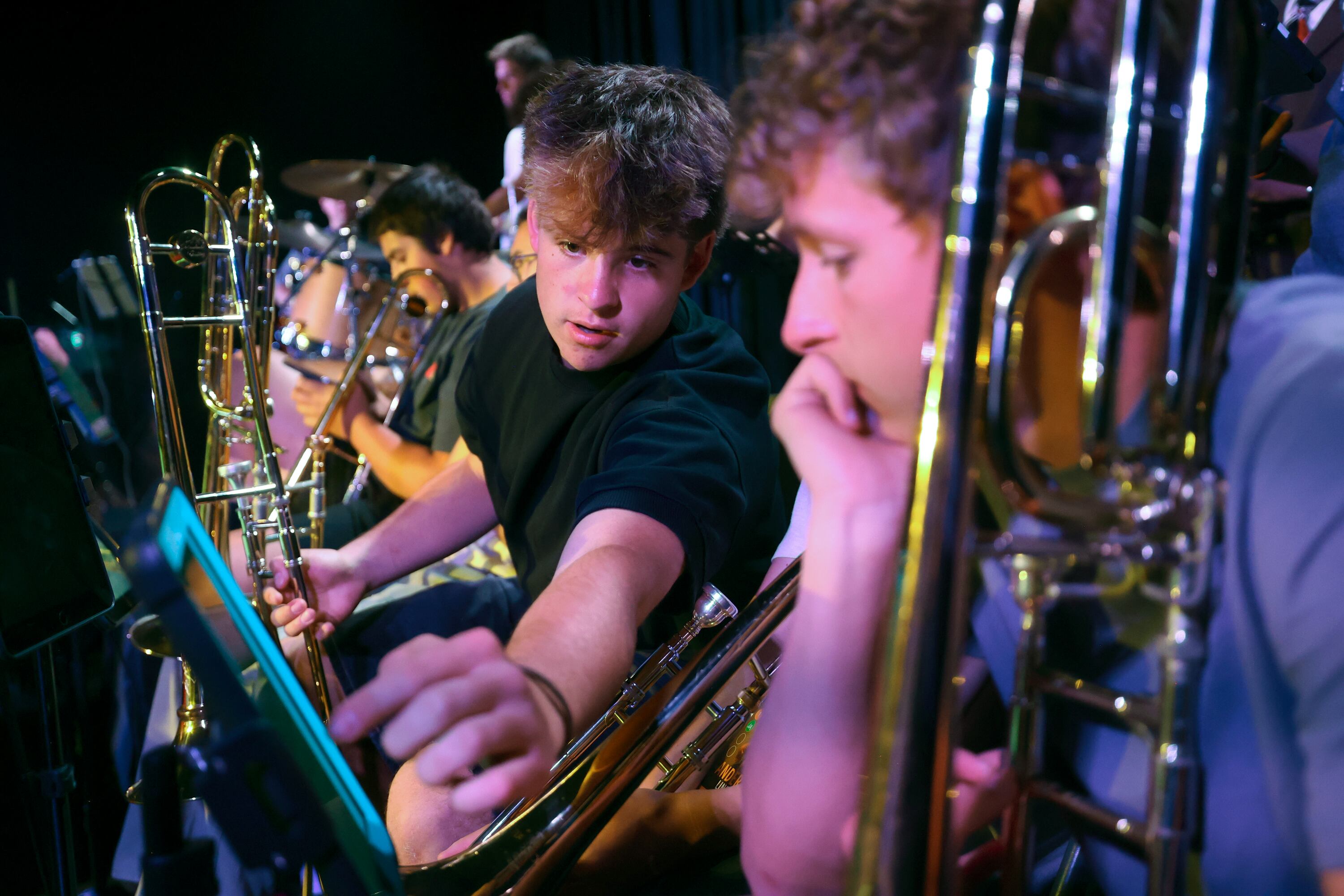 Grady Dedrickson and Tobey Streeter look at music while rehearsing with the Crescent Super Band at Caleb Chapman’s Soundhouse in Pleasant Grove on June 15.