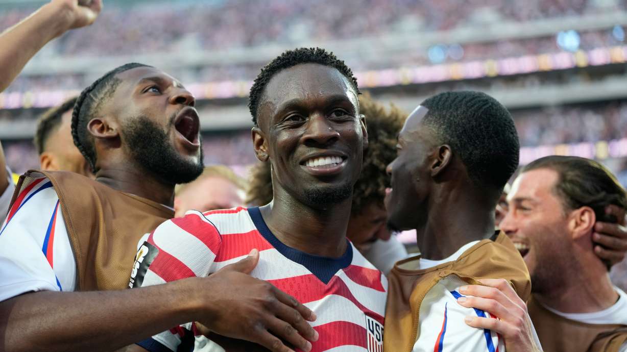 United States' Folarin Balogun, center, celebrates scoring his side's third goal against Paraguay with teamates during the World Cup Group D soccer match in Inglewood, Calif., near Los Angeles, Friday, June 12, 2026.