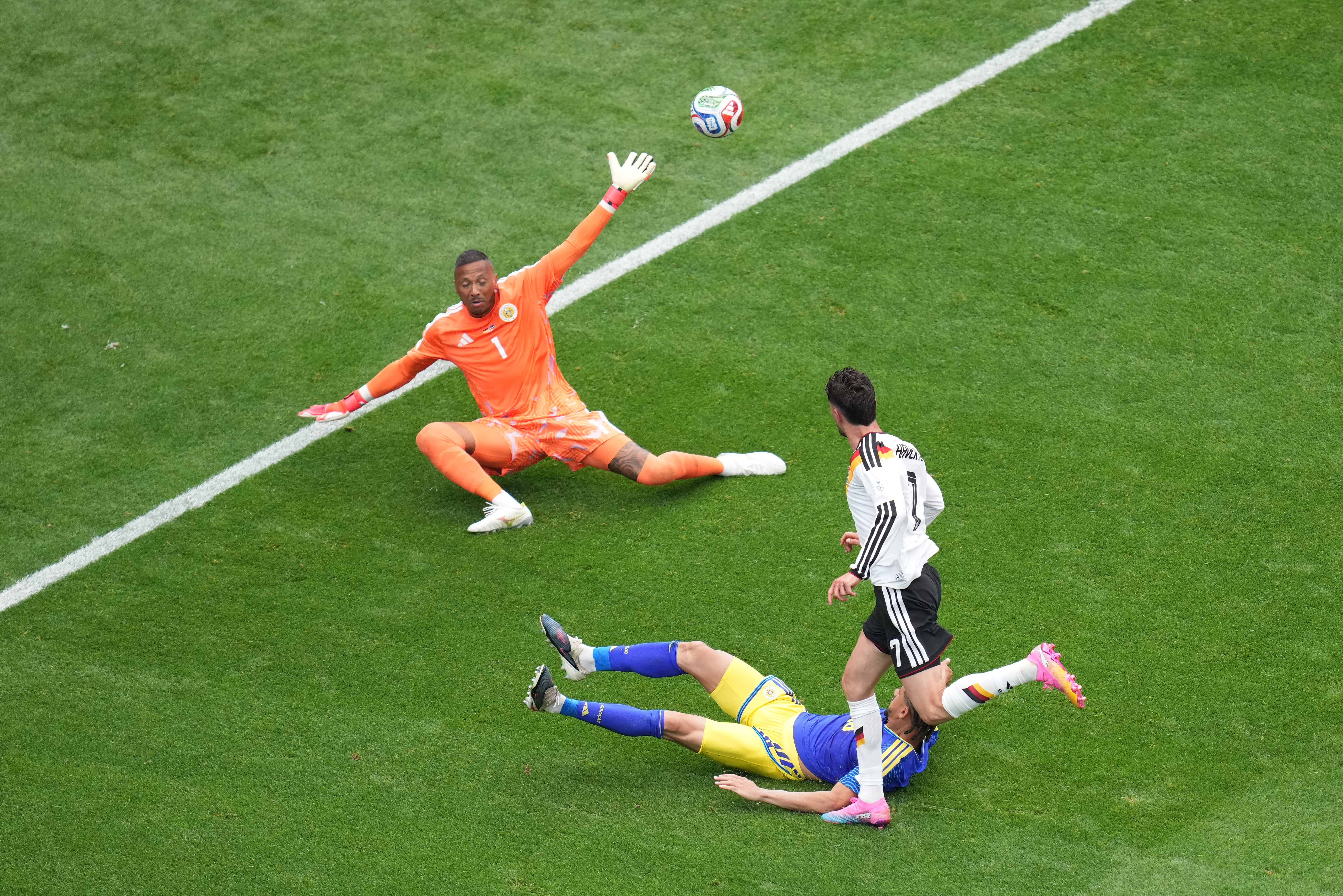 Germany's Kai Havertz (7) scores a goal against Curaçao goalkeeper Eloy Room (1) during the World Cup Group E soccer match between Germany and Curacao in Houston, Sunday, June 14, 2026.