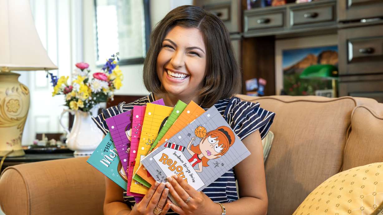 Mary Ann Jensen, 18, poses for photos at her home in Cottonwood Heights on Monday. Jensen just completed her seventh self-published book.