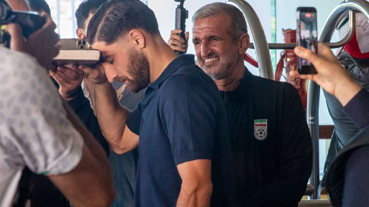 Iran national soccer team member Alireza Jahanbakhsh touches his forehead to the Quran as he departs from the Tijuana Marriott in Tijuana, Mexico on Saturday June 20, 2026.