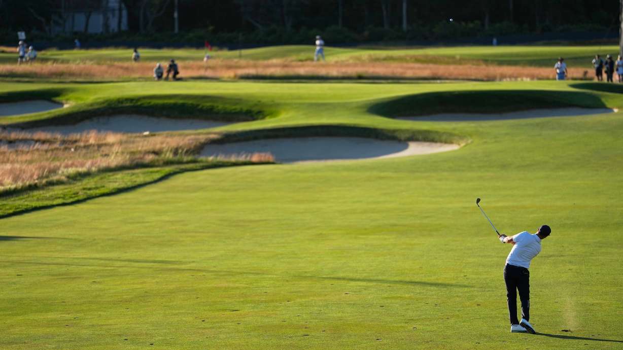 Wyndham Clark hits from the fairway on the 15th hole during the third round of the U.S. Open golf tournament at Shinnecock Hills Golf Club in Southampton, N.Y., Saturday, June 20, 2026.