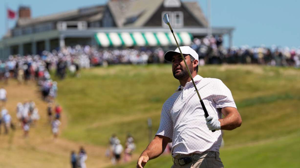 Scottie Scheffler watches his shot on the first hole during the third round of the U.S. Open golf tournament at Shinnecock Hills Golf Club in Southampton, N.Y., Saturday, June 20, 2026.