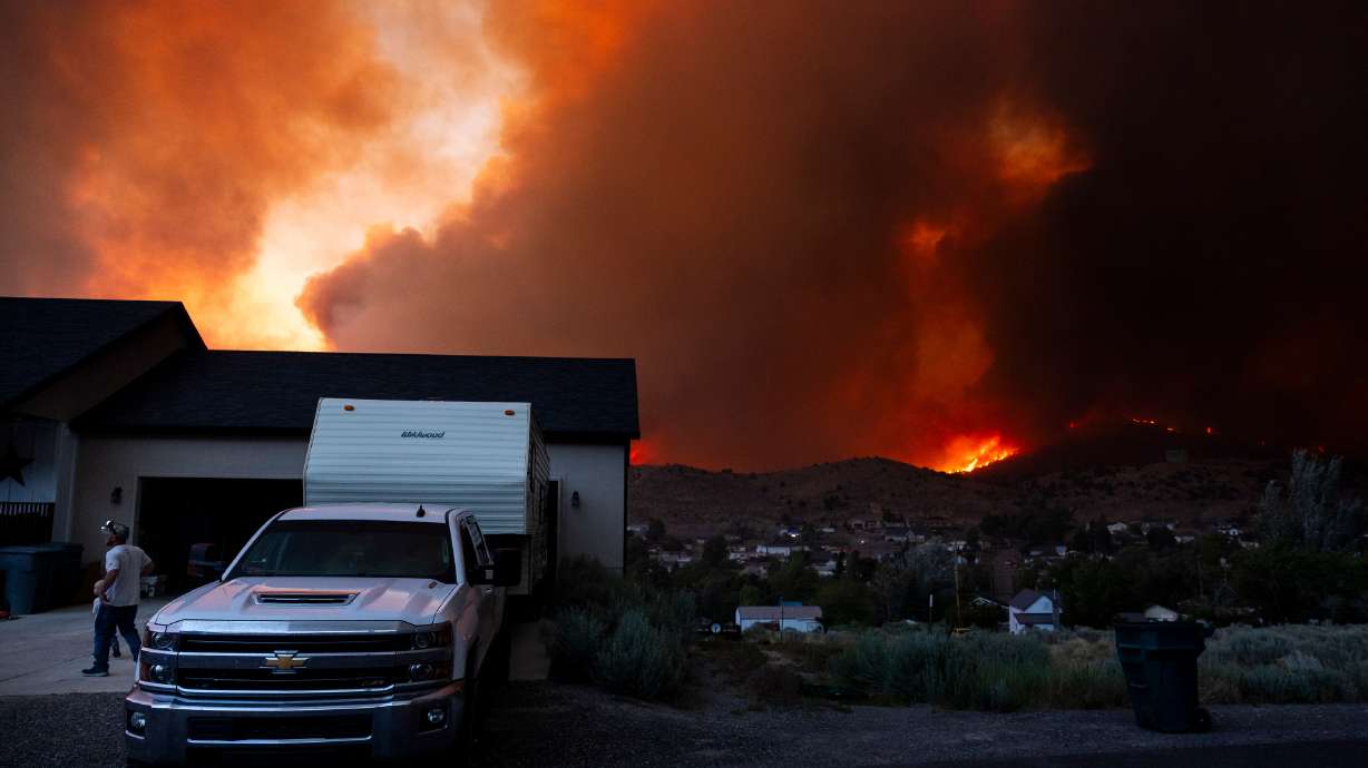 Residents rush to evacuate as winds drive the Iron Fire toward Eureka on Saturday.