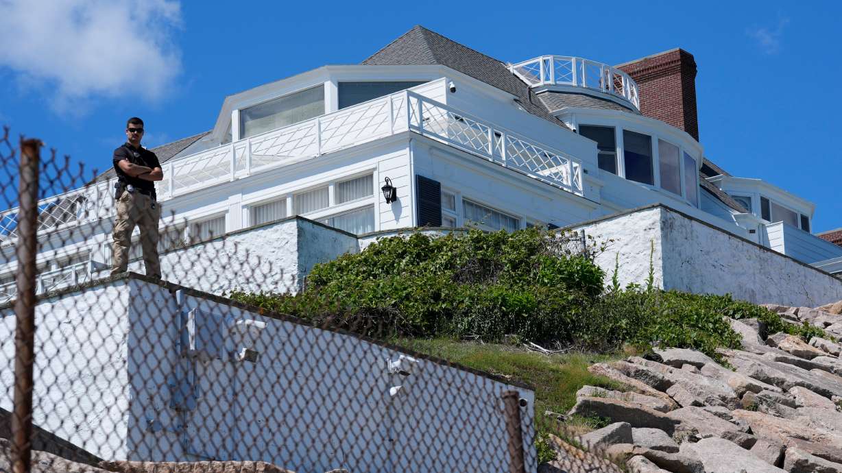 A security guard stands watch at Taylor Swift's "Holiday House," Saturday, June 20, 2026, in Westerly, R.I.