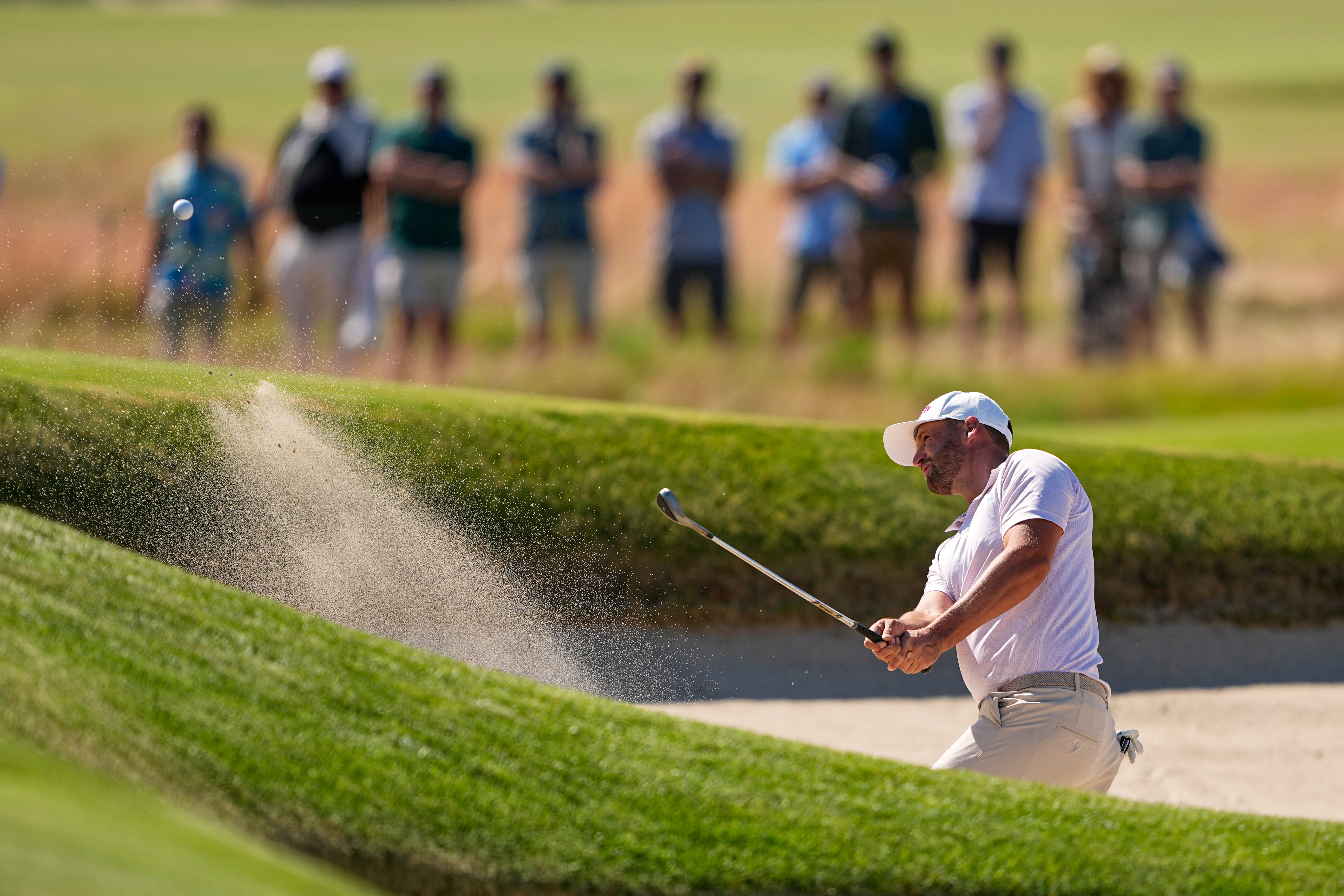 Wyndham Clark hits from the bunker on the seventh hole during the final round of the U.S. Open golf tournament at Shinnecock Hills Golf Club in Southampton, N.Y., Sunday, June 21, 2026.