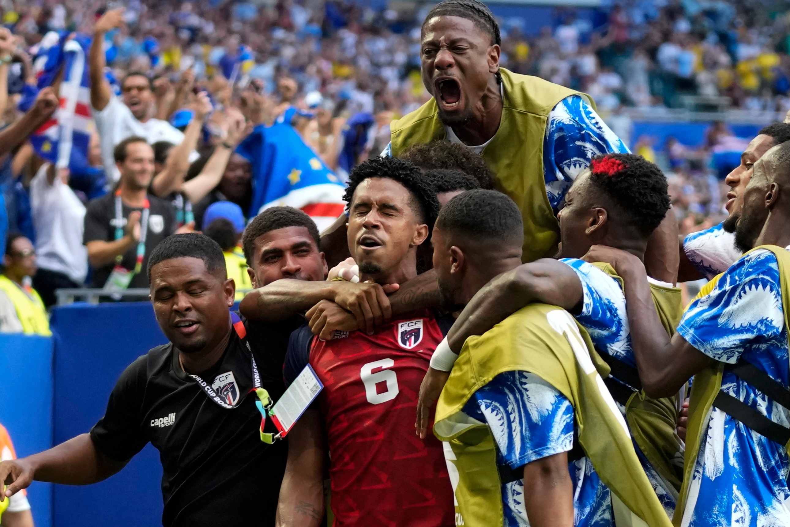 Cape Verde's Kevin Pina, center, celebrates with teammates after scoring the opening goal during the World Cup Group H soccer match between Uruguay and Cape Verde in Miami Gardens, Fla., Sunday, June 21, 2026.