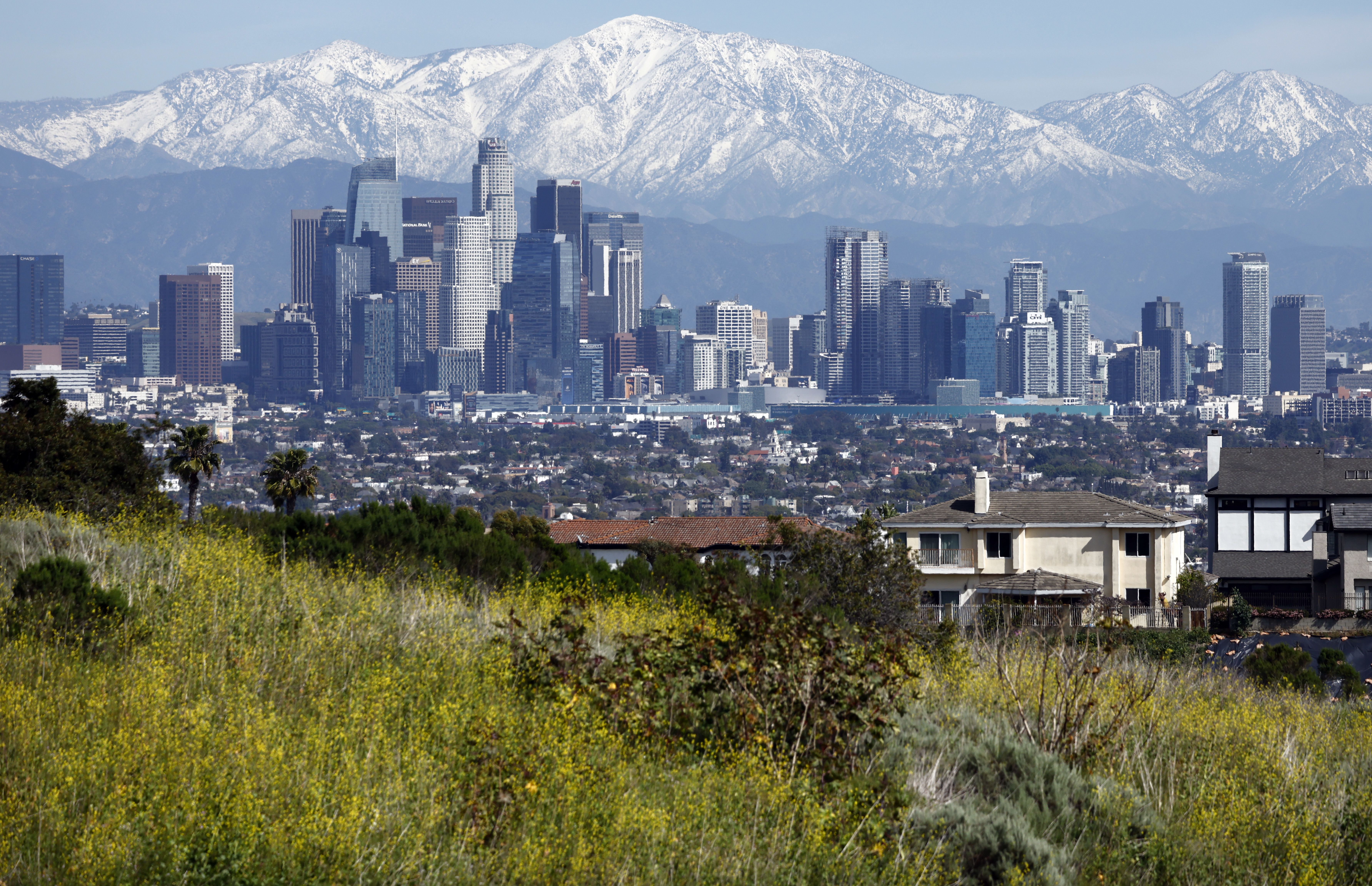 The downtown skyline stands with the San Gabriel Mountains visible behind on Feb. 23, in Los Angeles, California. The city is located in Southern California, which faces significant risk from increased seismic activity.
