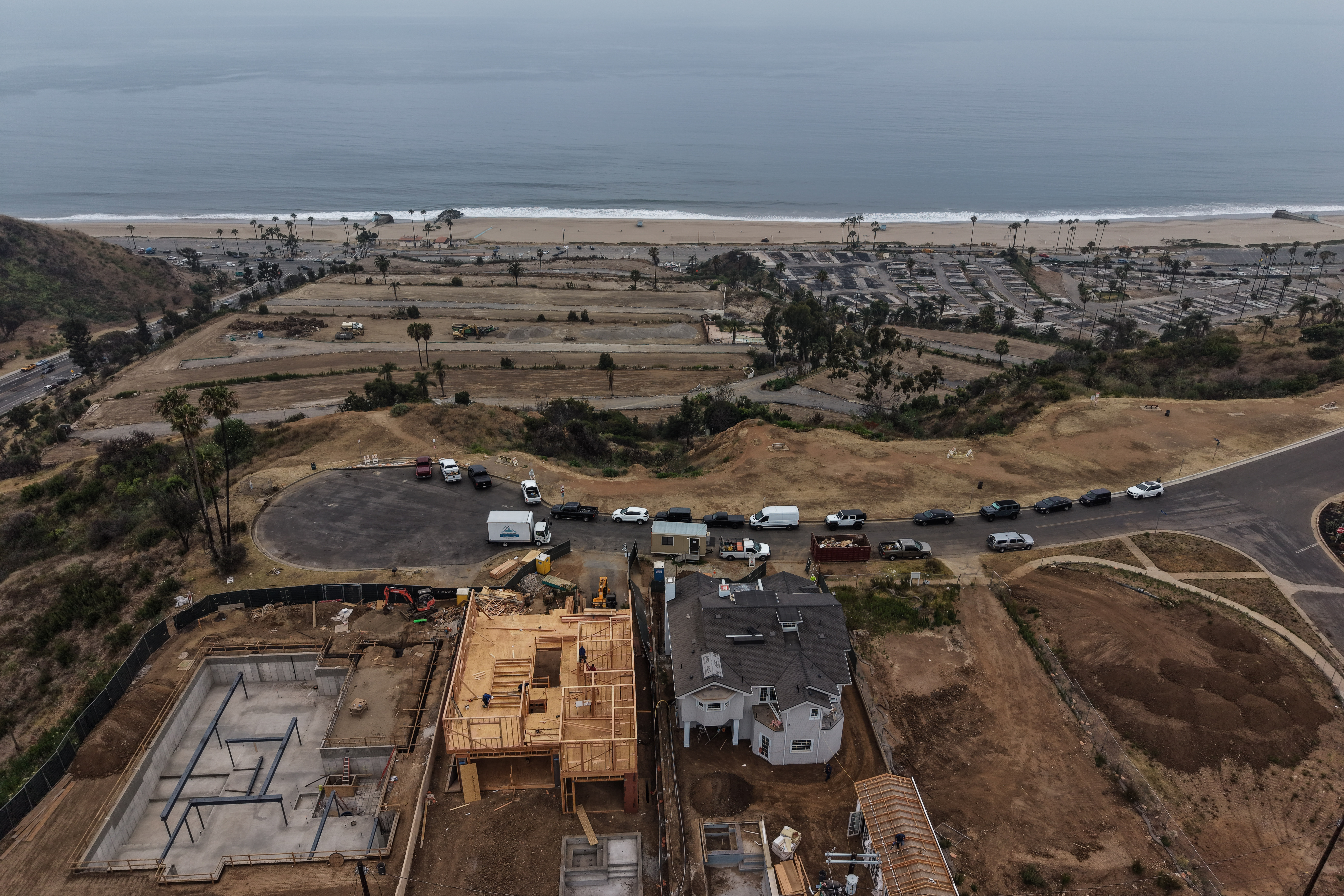 Homes under construction sit on a hillside overlooking the Pacific Ocean more than a year after the Palisades Fire in the Pacific Palisades neighborhood of Los Angeles, June 4. The trial of Jonathan Rinderknecht, accused of starting the fire, was declared a mistrial on Friday.