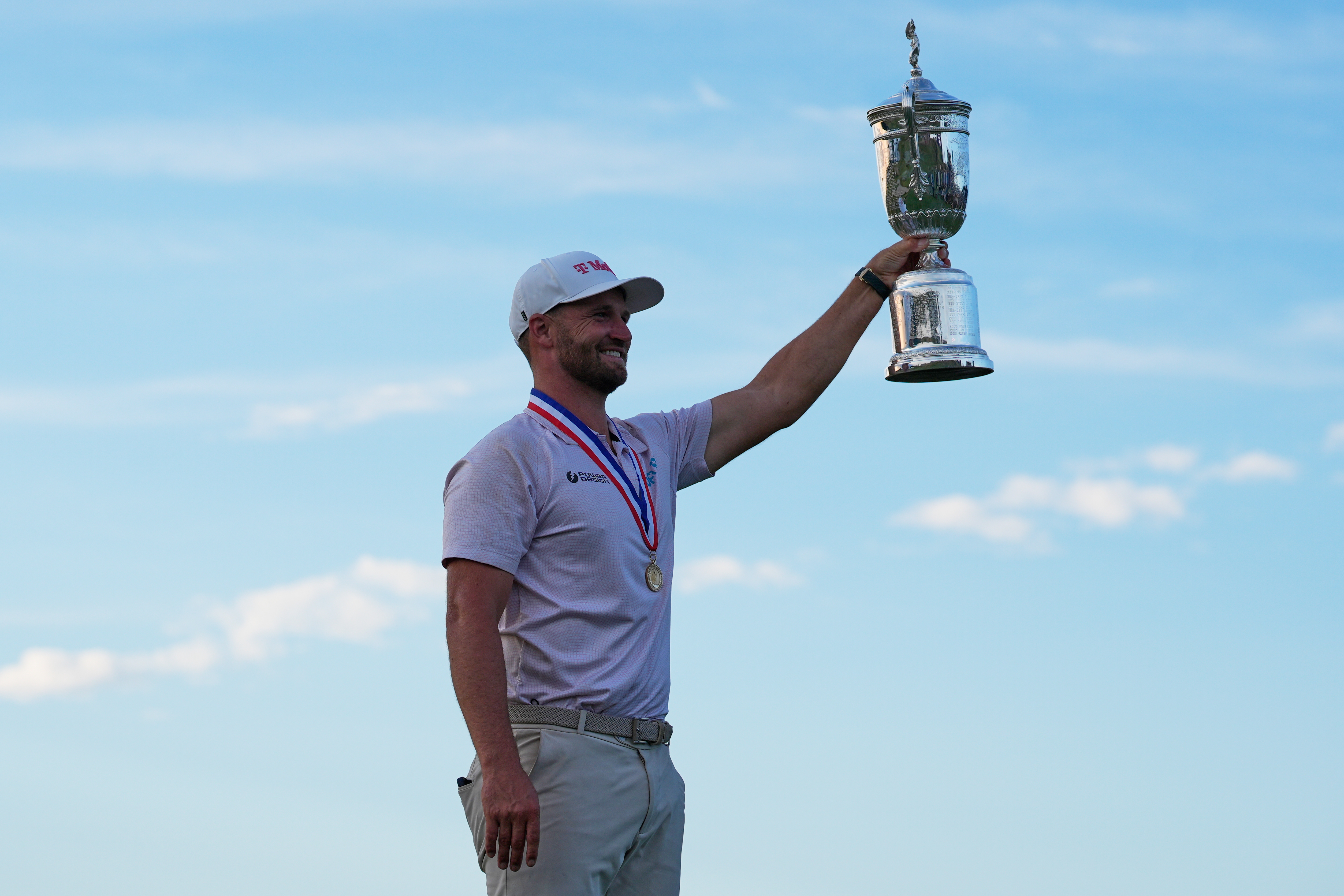 Wyndham Clark holds the trophy after winning the U.S. Open golf tournament at Shinnecock Hills Golf Club in Southampton, N.Y., Sunday, June 21, 2026.