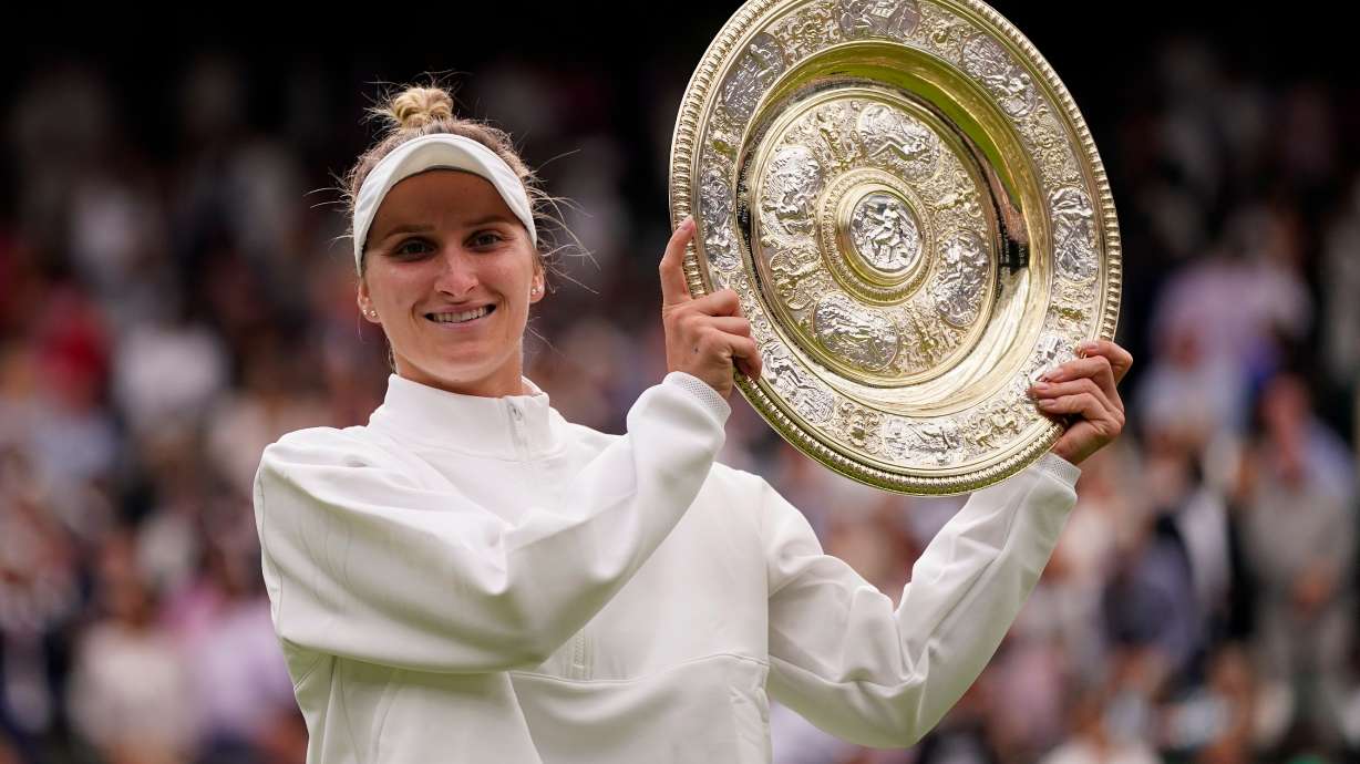 FILE - Czech Republic's Marketa Vondrousova celebrates with the trophy after beating Tunisia's Ons Jabeur to win the final of the women's singles on day thirteen of the Wimbledon tennis championships in London, Saturday, July 15, 2023.