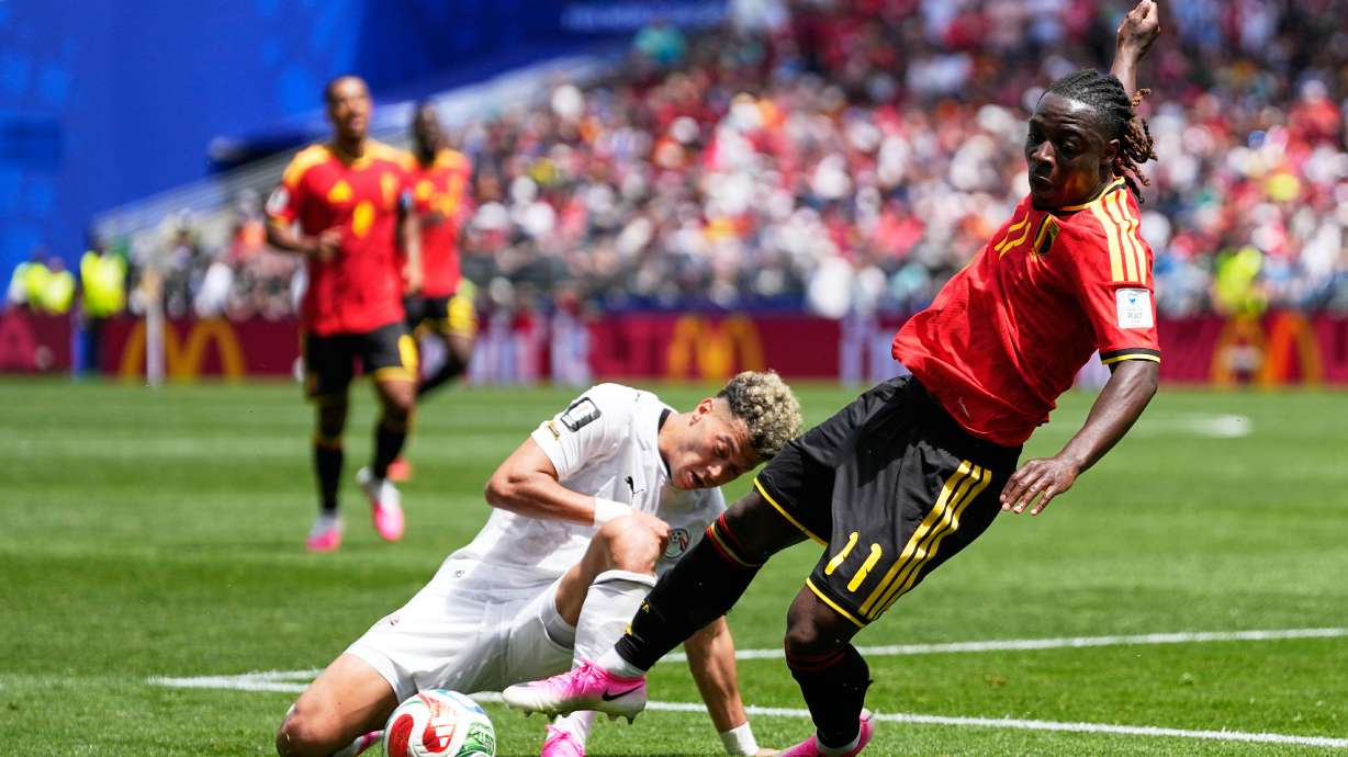 Belgium's Jeremy Doku, front, and Egypt's Emam Ashour fight for the ball during the World Cup Group G soccer match in Seattle, Monday, June 15, 2026.