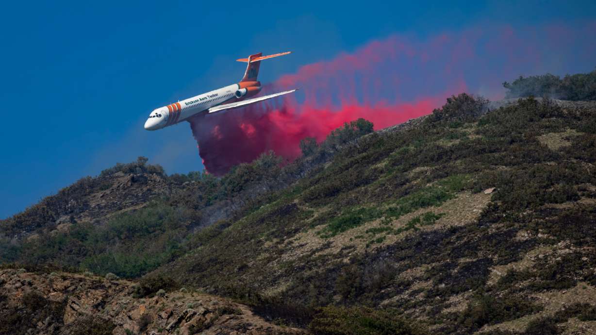 An Erickson Aero Tanker drops fire retardants on the Bonneville Fire above the University of Utah in Salt Lake City on Sunday.