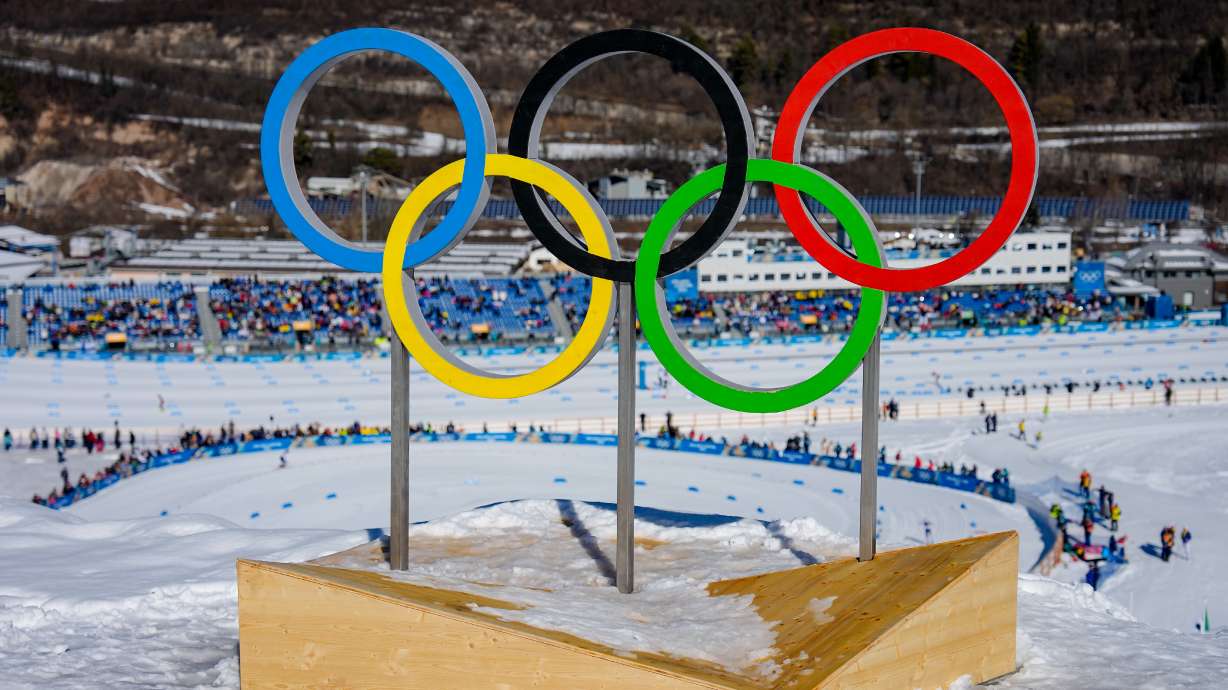 FILE - The Olympic rings stand above the course during the cross country skiing women's 50km mass start classic at the 2026 Winter Olympics, in Tesero, Italy, Feb. 22, 2026.