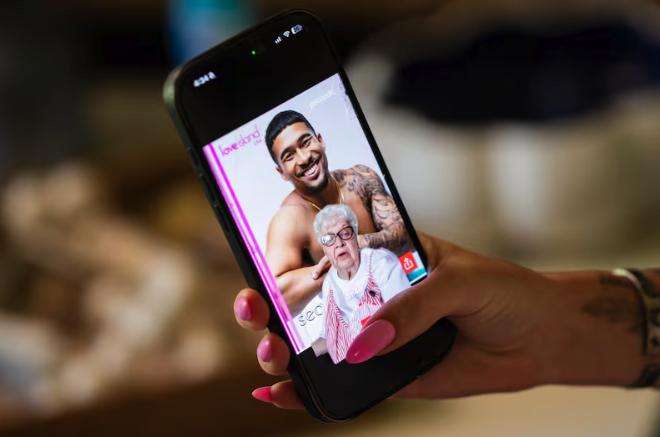 Shelby Coleman, off camera, records on her phone as she and her grandmother VaLynne Thompson, center, film a TikTok where Thompson ranks the newest “Love Island” cast at Thompson’s home in Mapleton on June 4. The pair run a TikTok account together.