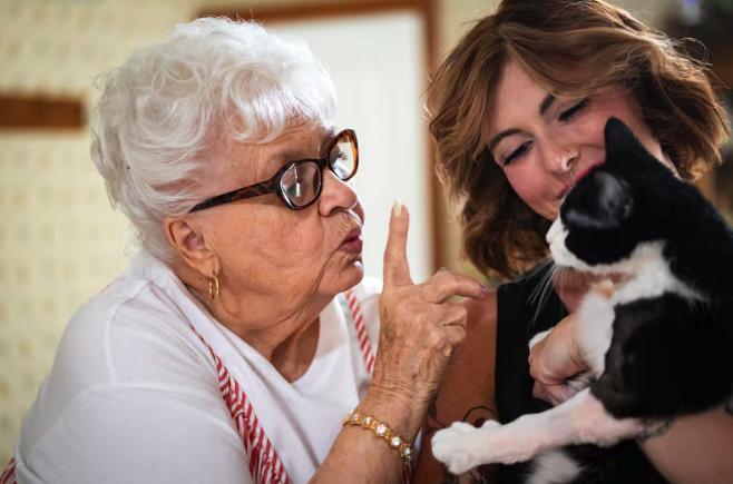Shelby Coleman, right, her grandmother VaLynne Thompson, left, and Thompson’s cat, Poppy, pose at Thompson’s home in Mapleton on June 4. The pair run a TikTok account together. Poppy appears in many of the videos.