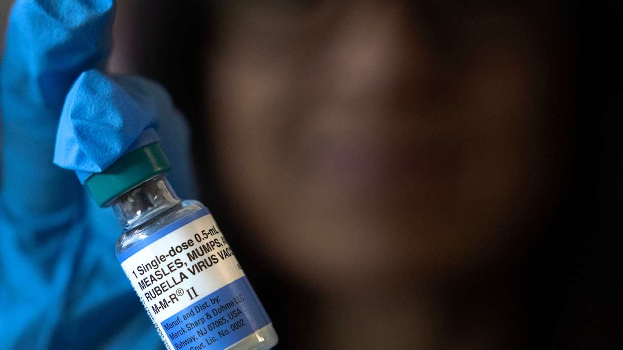 Jody deJonge, R.N., holds a multi-dose vial of the measles, mumps and rubella virus vaccination at the Salt Lake Public Health Center in Salt Lake City on July 9, 2025. Utah's measles outbreak is a year old.