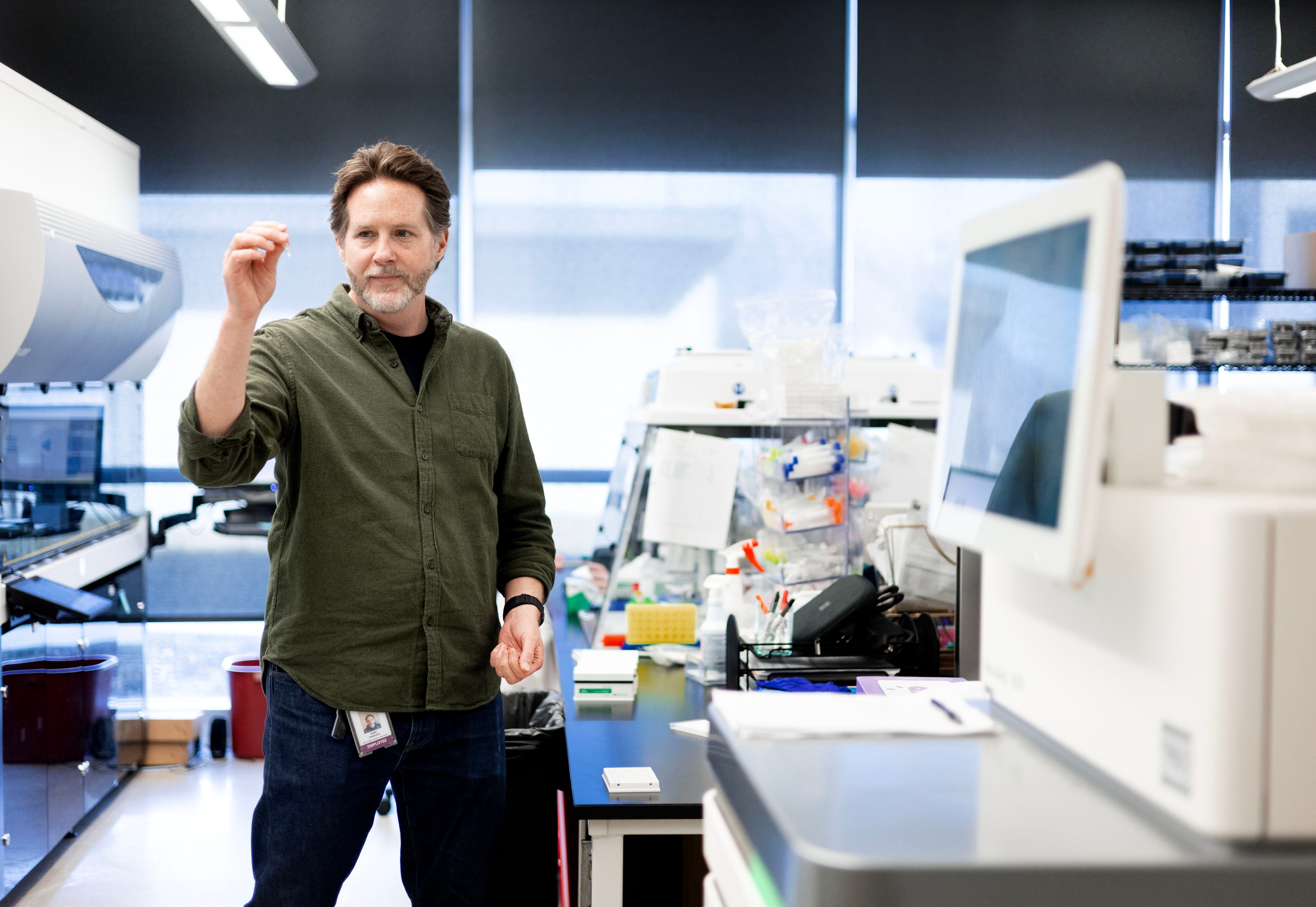 Kelly Oakeson, principal investigator at the Utah Department of Health, holds a tube of concentrated wastewater genetic material at the Utah Public Health Lab in Taylorsville on March 19.