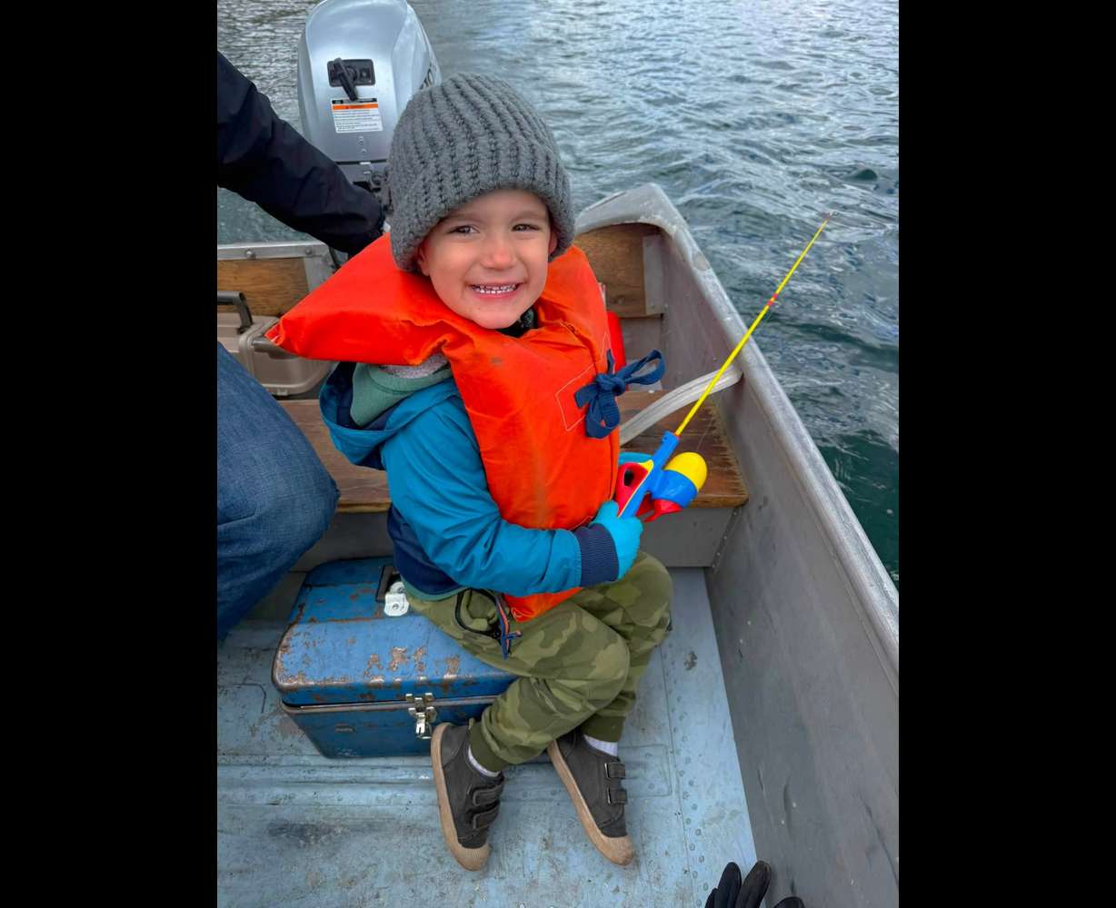 Jackson West, 3, poses for a picture during an annual family trip to Fish Lake. The family's fishing boat began to sink after a sudden storm flooded it on May 29. The family of seven all had life jackets on except for mother, Heather West, who swam Jackson to safety, nearly at the cost of her own life.