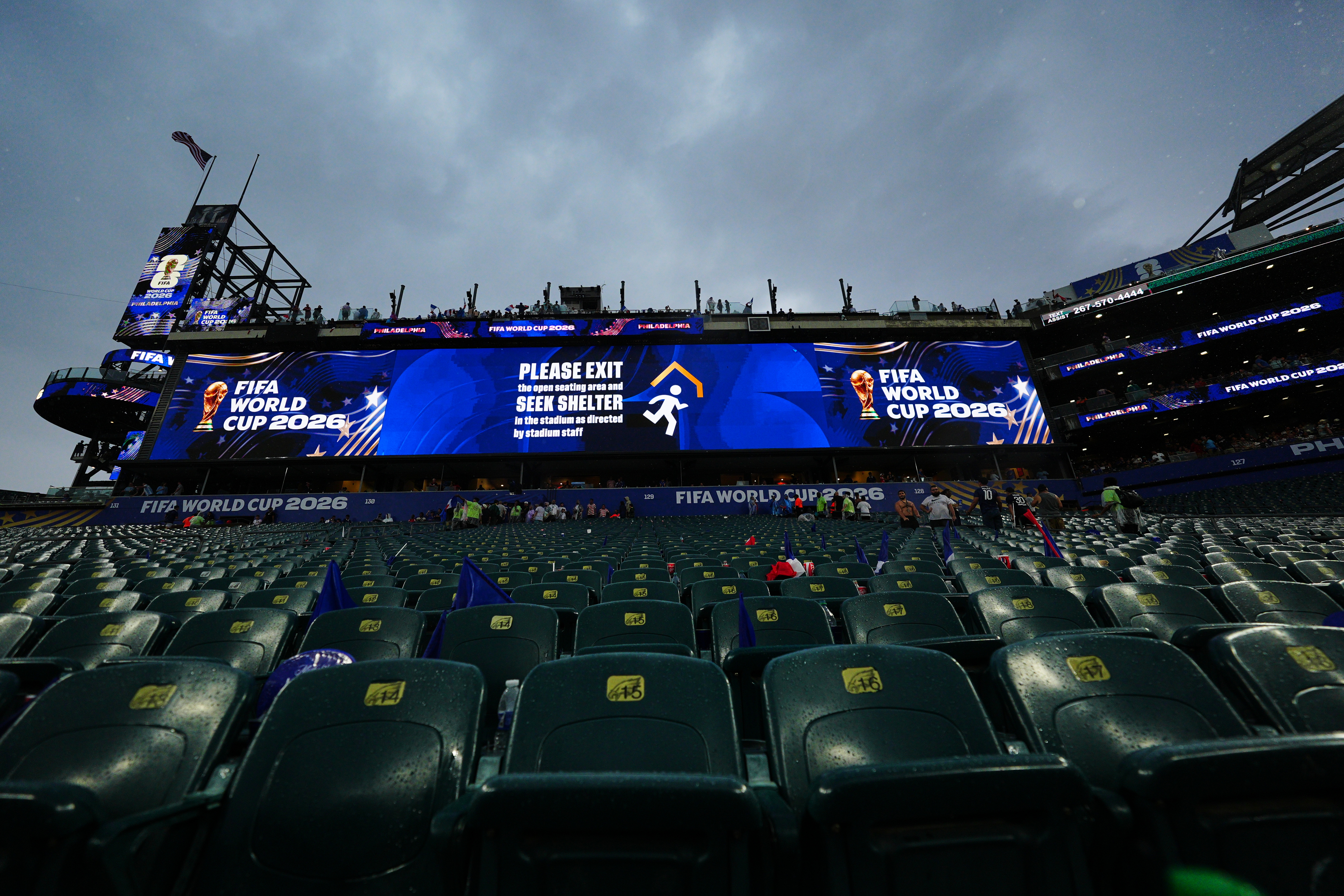 A sign advising fans of a weather delay is displayed during the World Cup Group I soccer match between France and Iraq in Philadelphia, Monday, June 22, 2026.