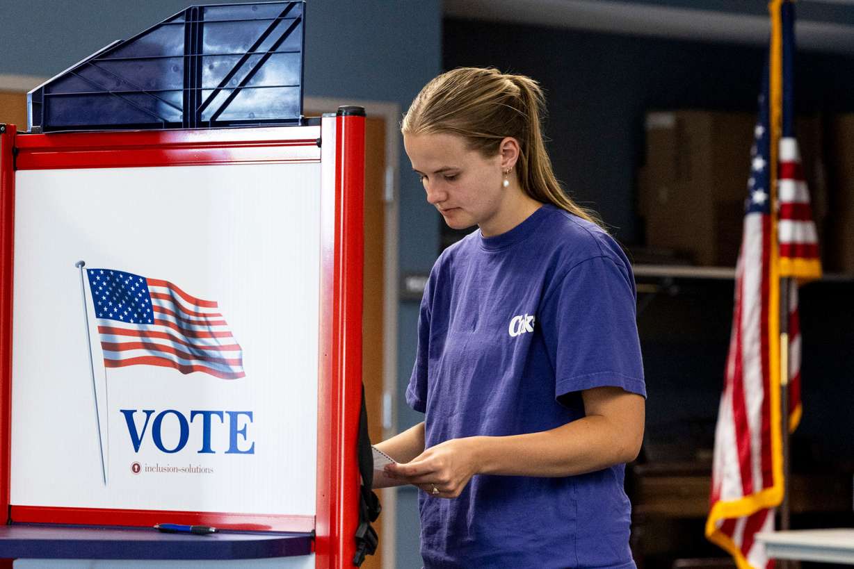 April Greenwood, of Provo, looks over her ballot during primary election voting held at the Utah County Health and Justice Building in Provo on June 25, 2024. Mail-in voting will look different this year for Utah voters.