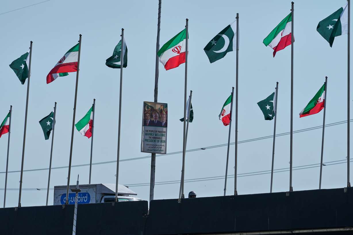The welcoming billboard, featuring Iranian President Masoud Pezeshkian, with Pakistan President Asif Ali Zardari and Prime Minister Shehbaz Sharif, is displayed alongside of an overhead bridge, in Islamabad, Pakistan, Tuesday. Pezeshkian made his first visit since the war started.