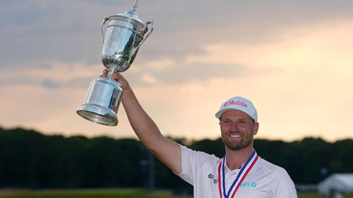 Wyndham Clark holds the trophy after winning the U.S. Open golf tournament at Shinnecock Hills Golf Club in Southampton, N.Y., Sunday, June 21, 2026.